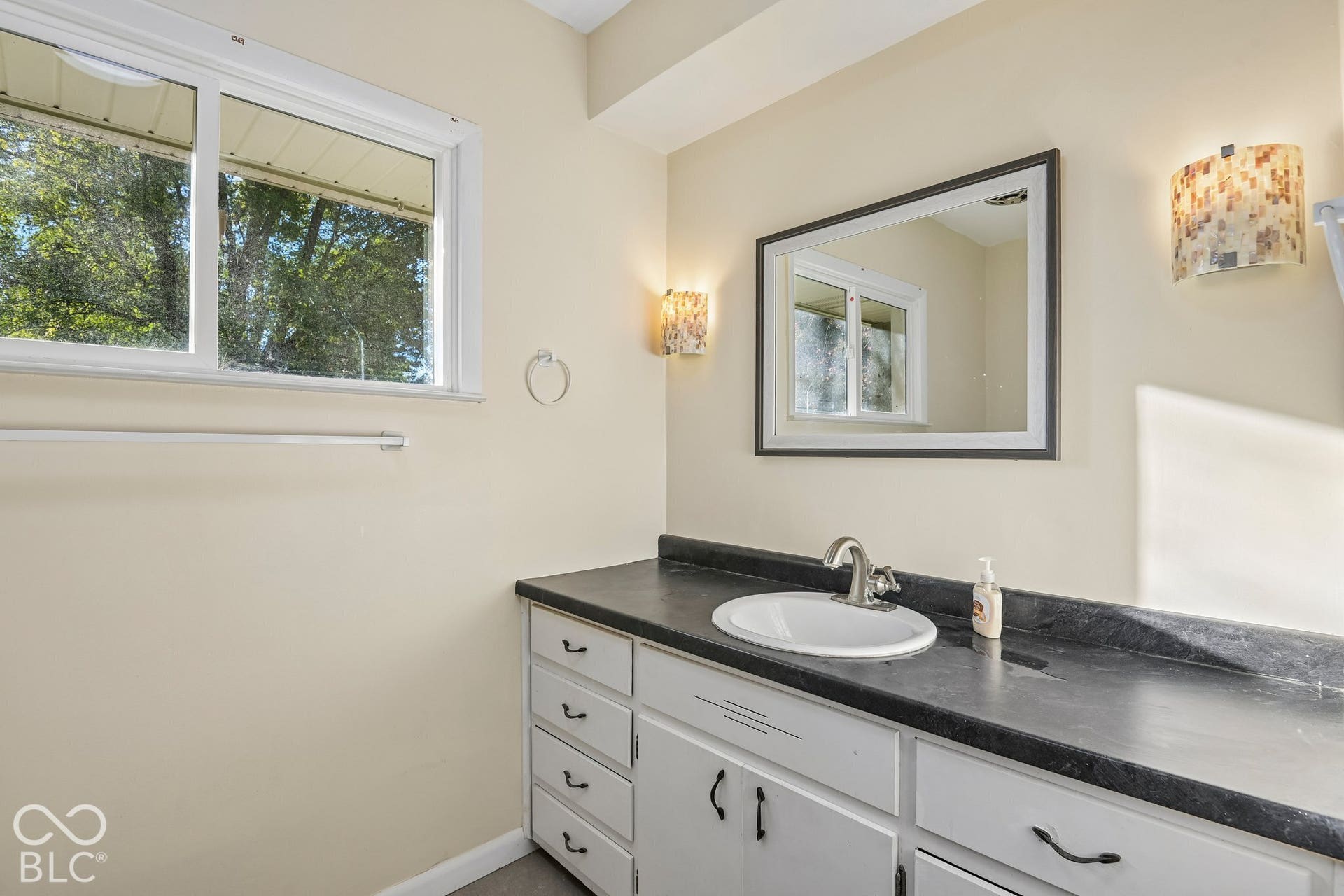 Vanity with an integrated sink and brushed nickel faucet