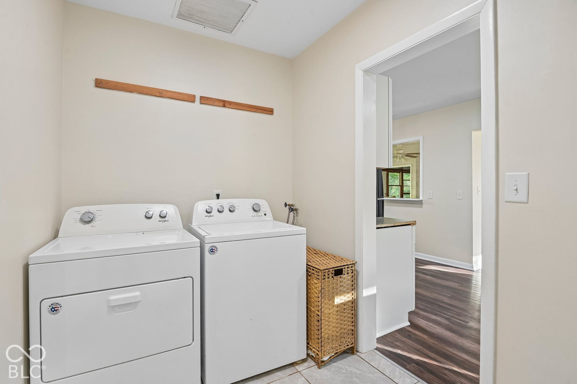 Utility area with tiled flooring and light-toned walls