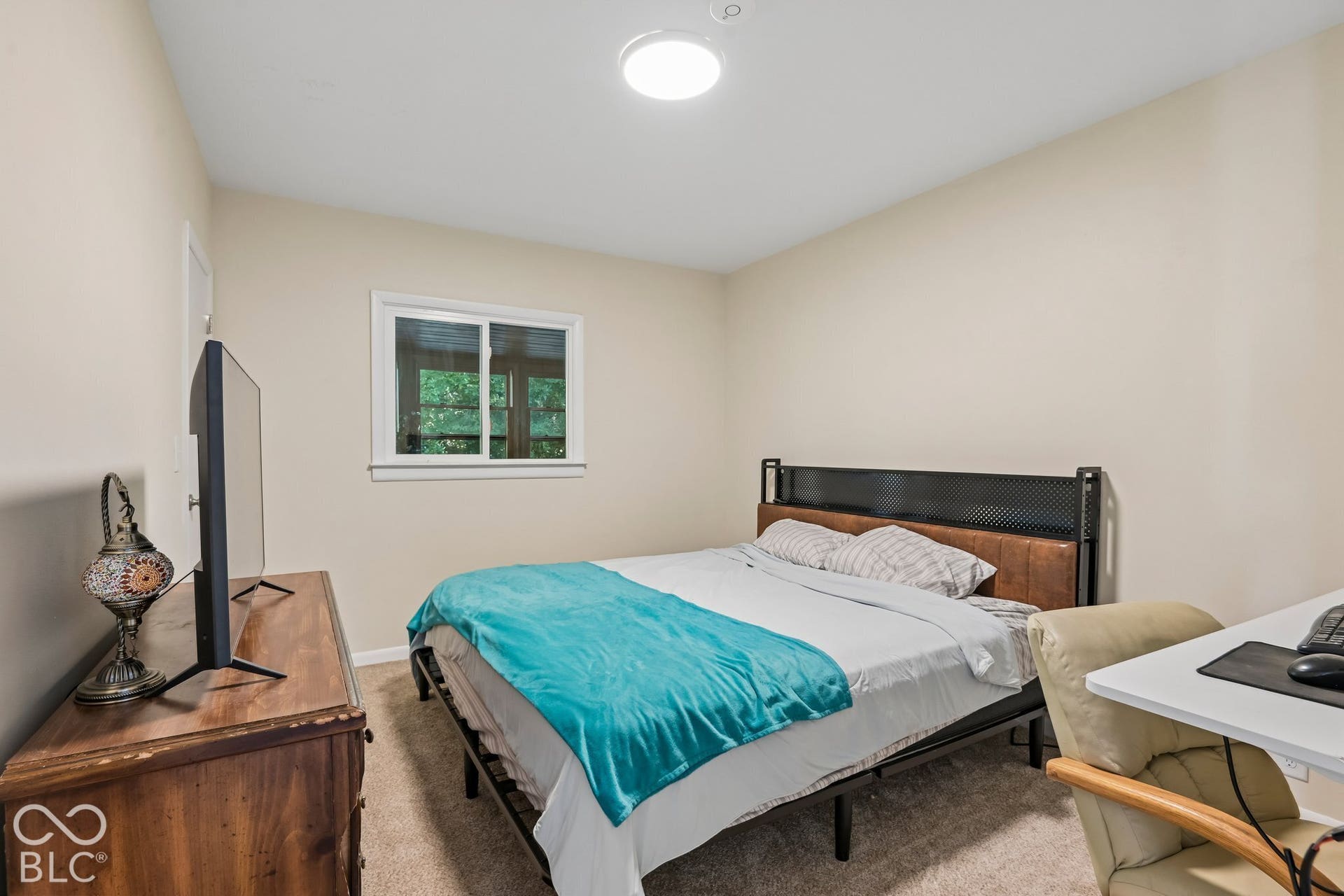 Neutral-toned walls complement the carpeted flooring