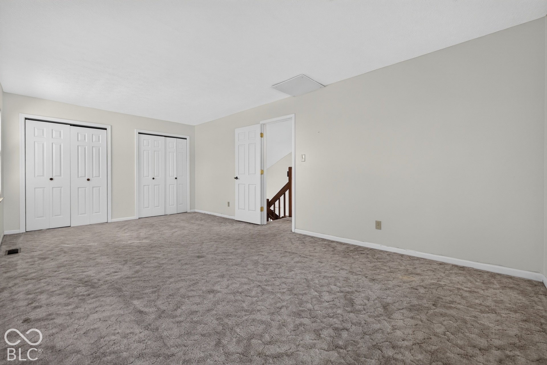 Expansive carpeted area with neutral wall finishes