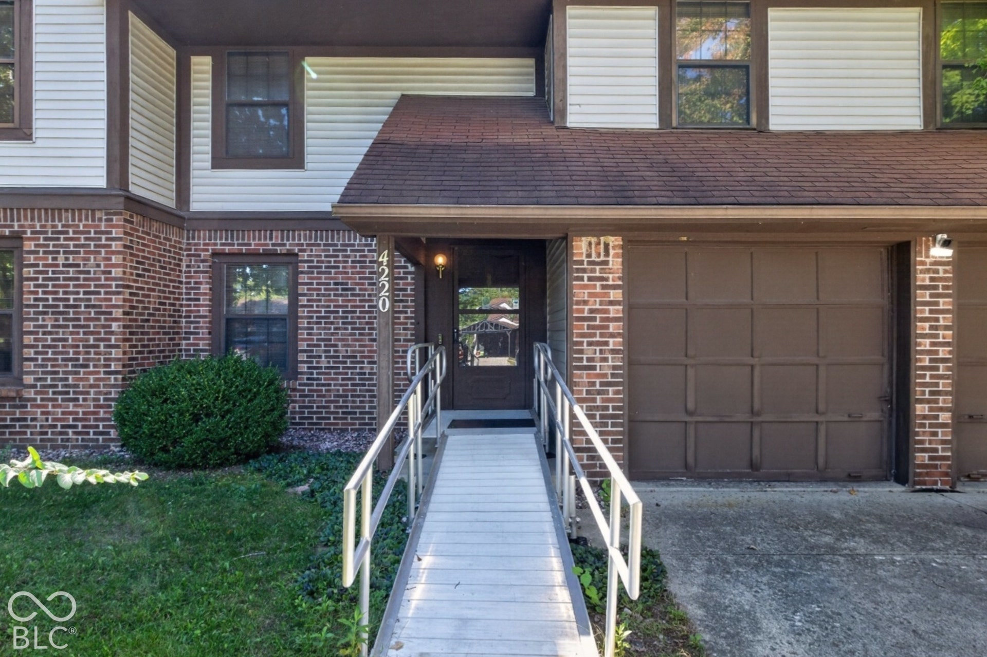 Brick and siding exterior with a shingled roof