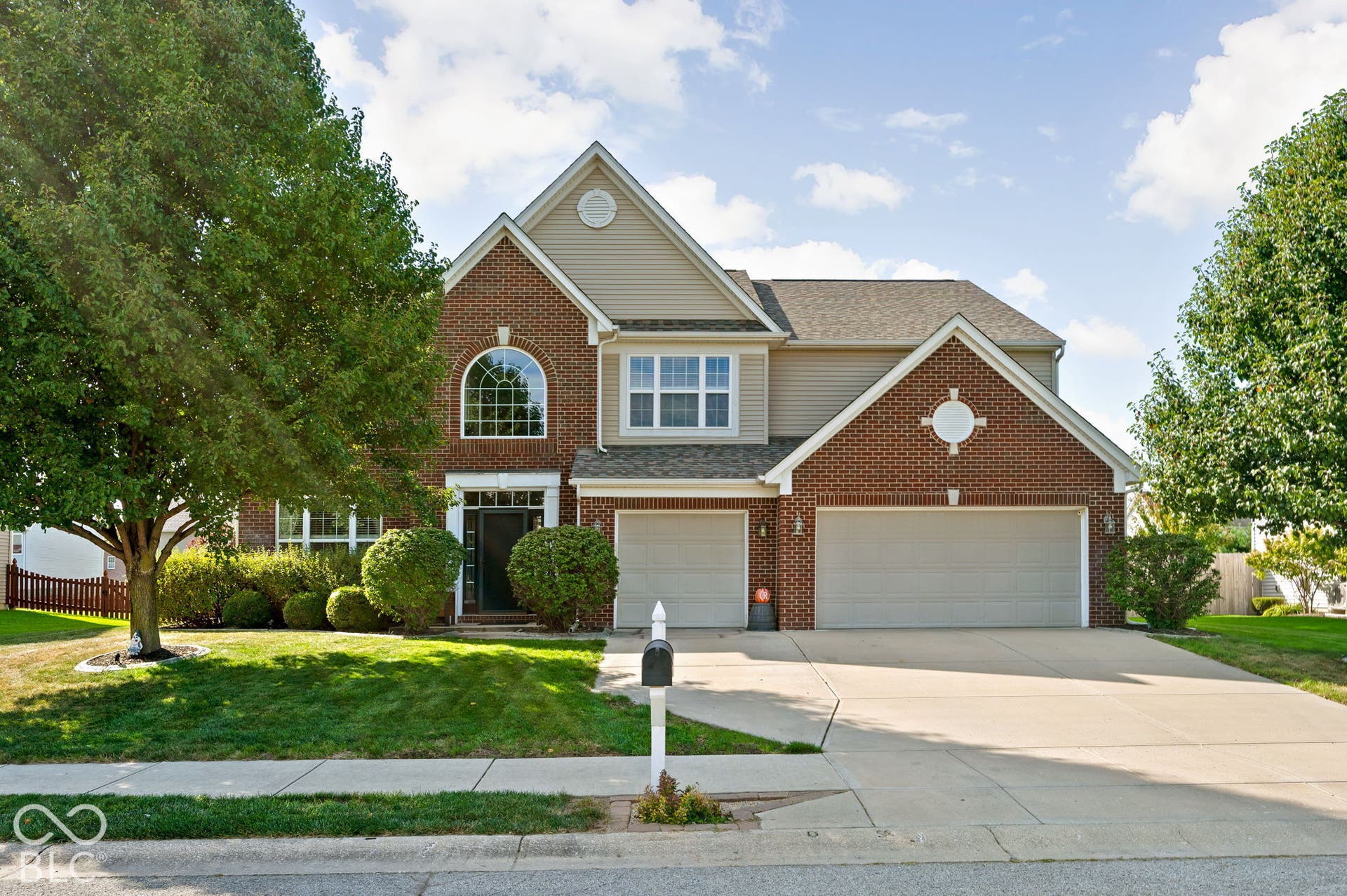 Brick and siding exterior with a two-car garage