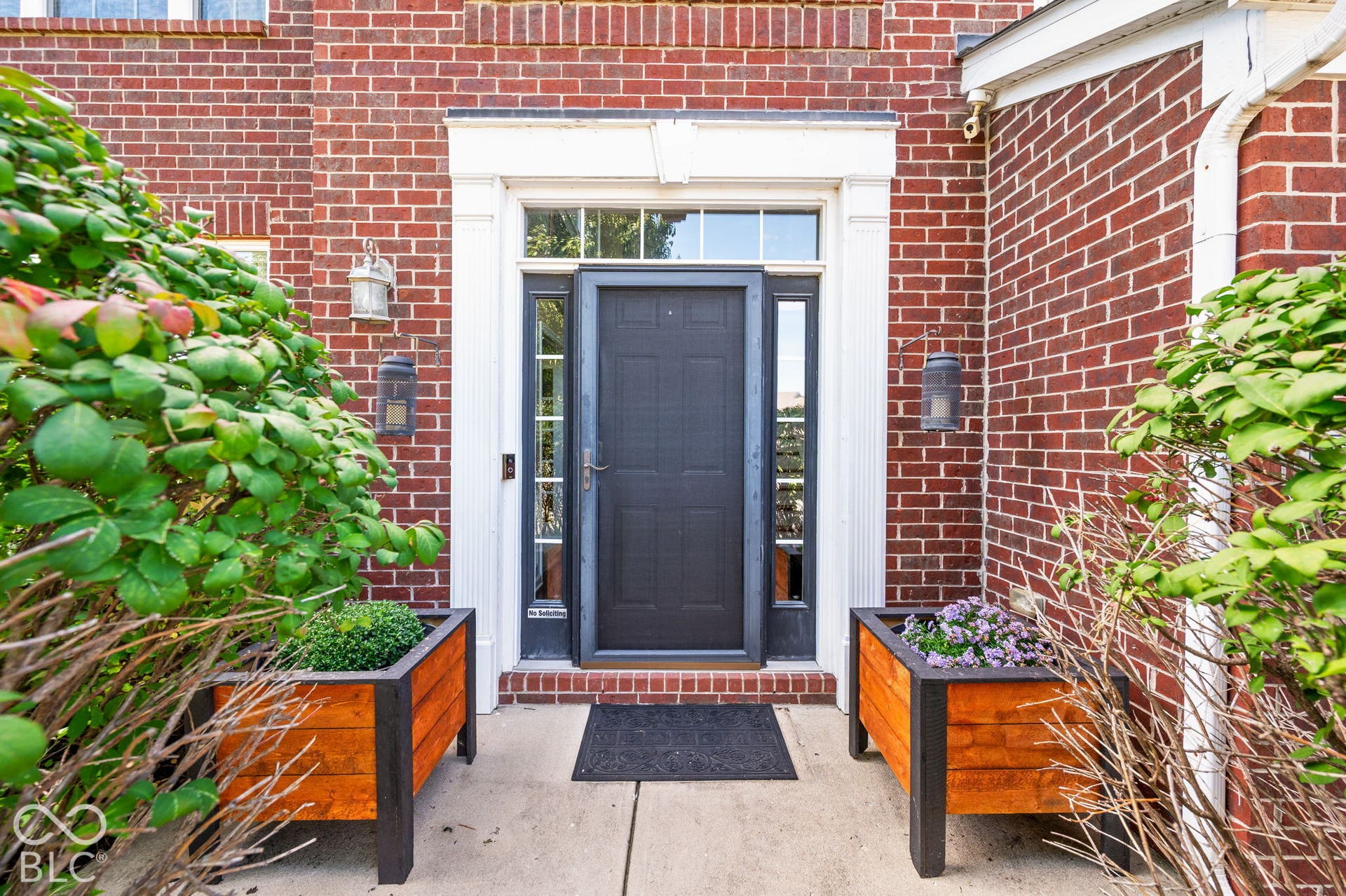 Brick facade with white trim around the entrance