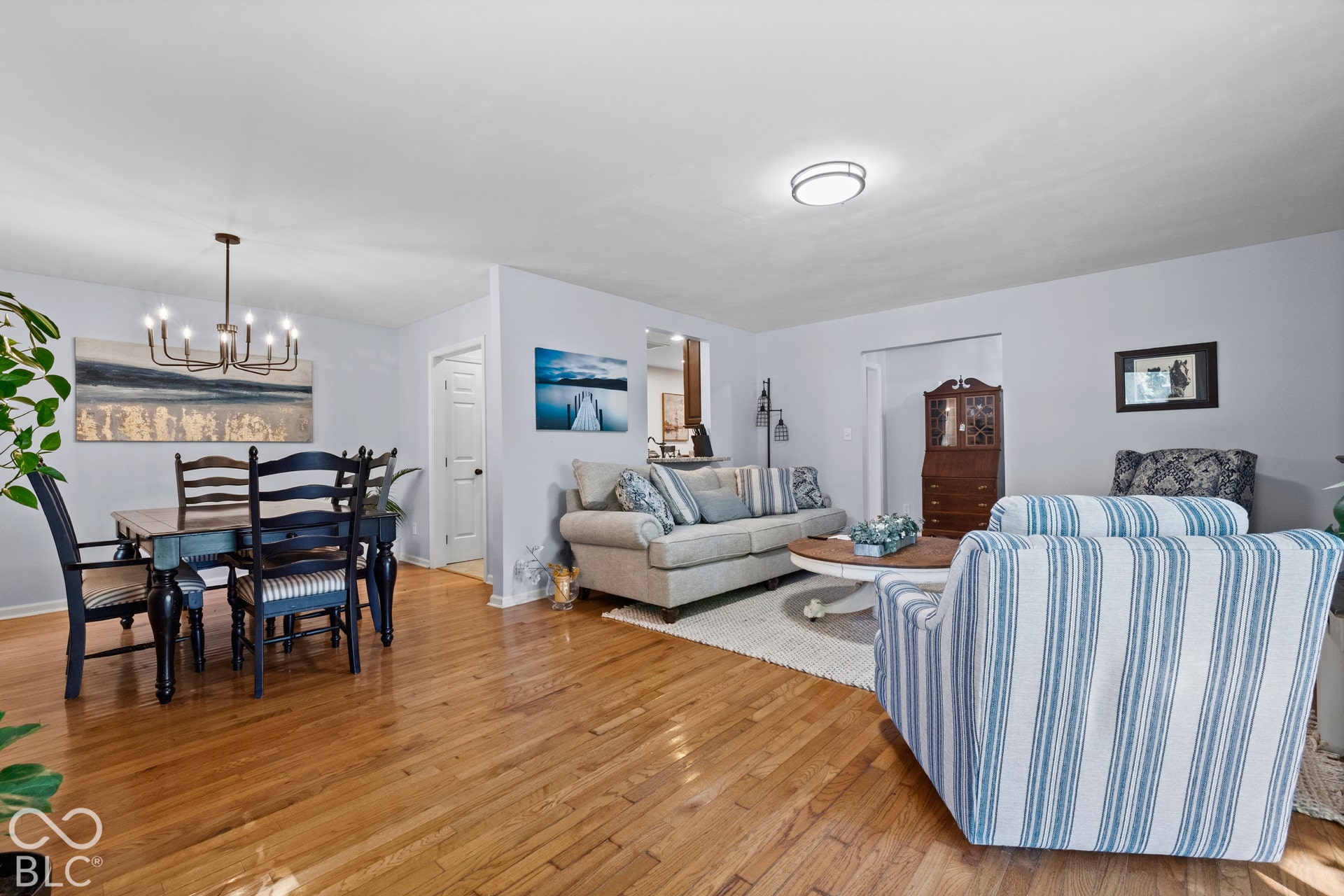 Hardwood flooring throughout, recessed lighting, and a modern chandelier