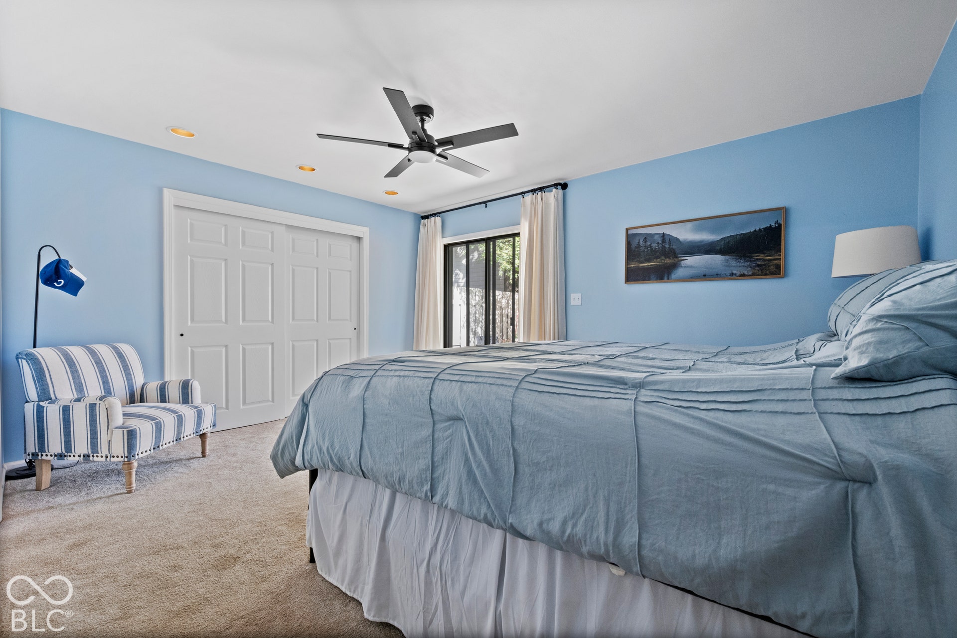 Recessed lighting, ceiling fan, sliding door closet, sliding glass door, and carpet flooring