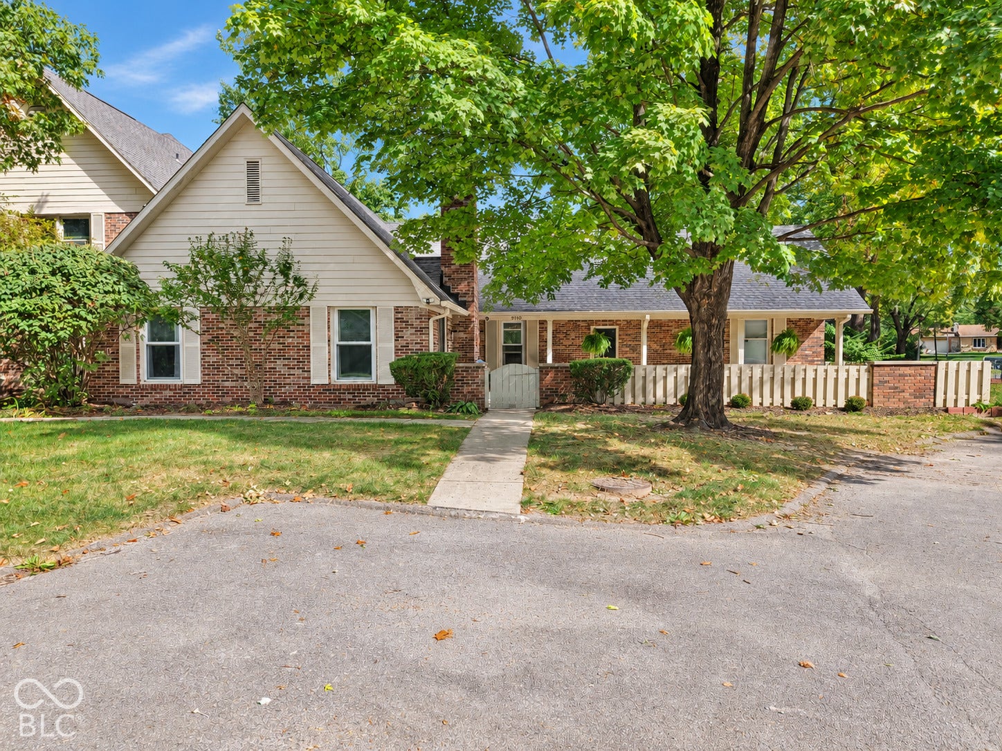 Brick exterior with white siding accents and a pitched roofline