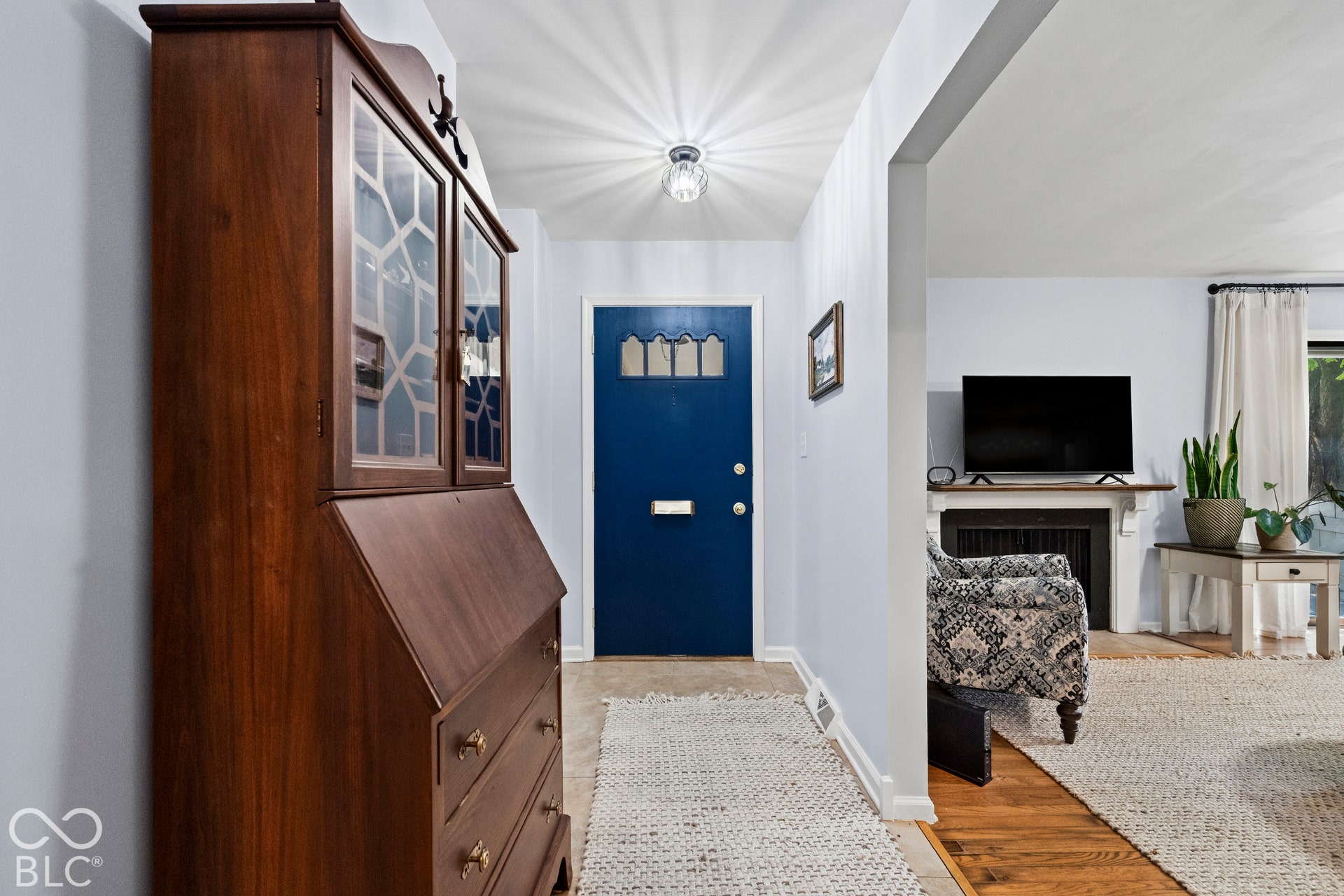 Entryway featuring a decorative ceiling light fixture and wood-finish flooring