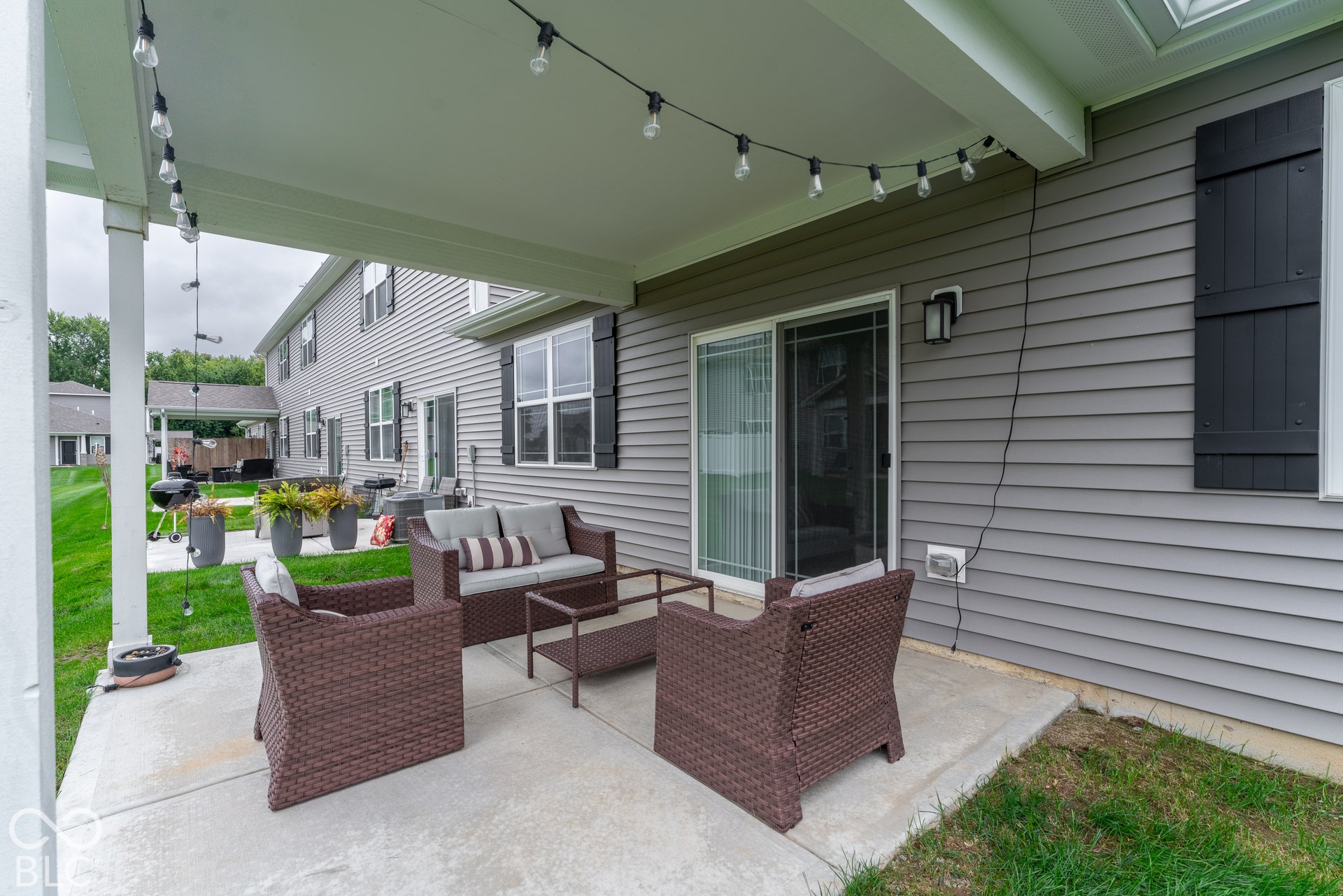 6432 Yuma, Whitestown, IN 46075 Covered patio with string lighting, gray siding, and black exterior shutters