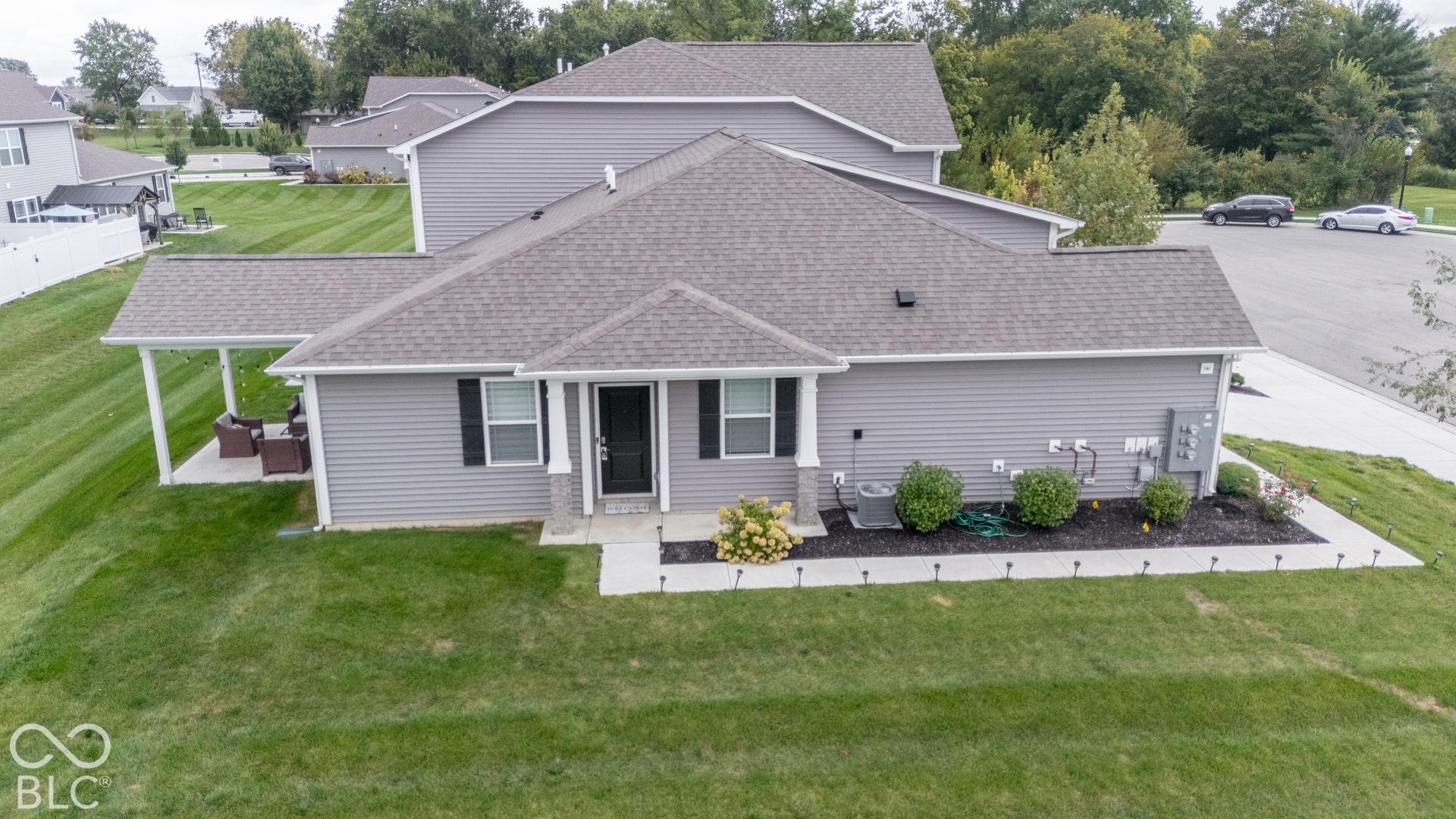 6432 Yuma, Whitestown, IN 46075 Gray siding exterior with a covered patio, front entry porch, and paved driveway