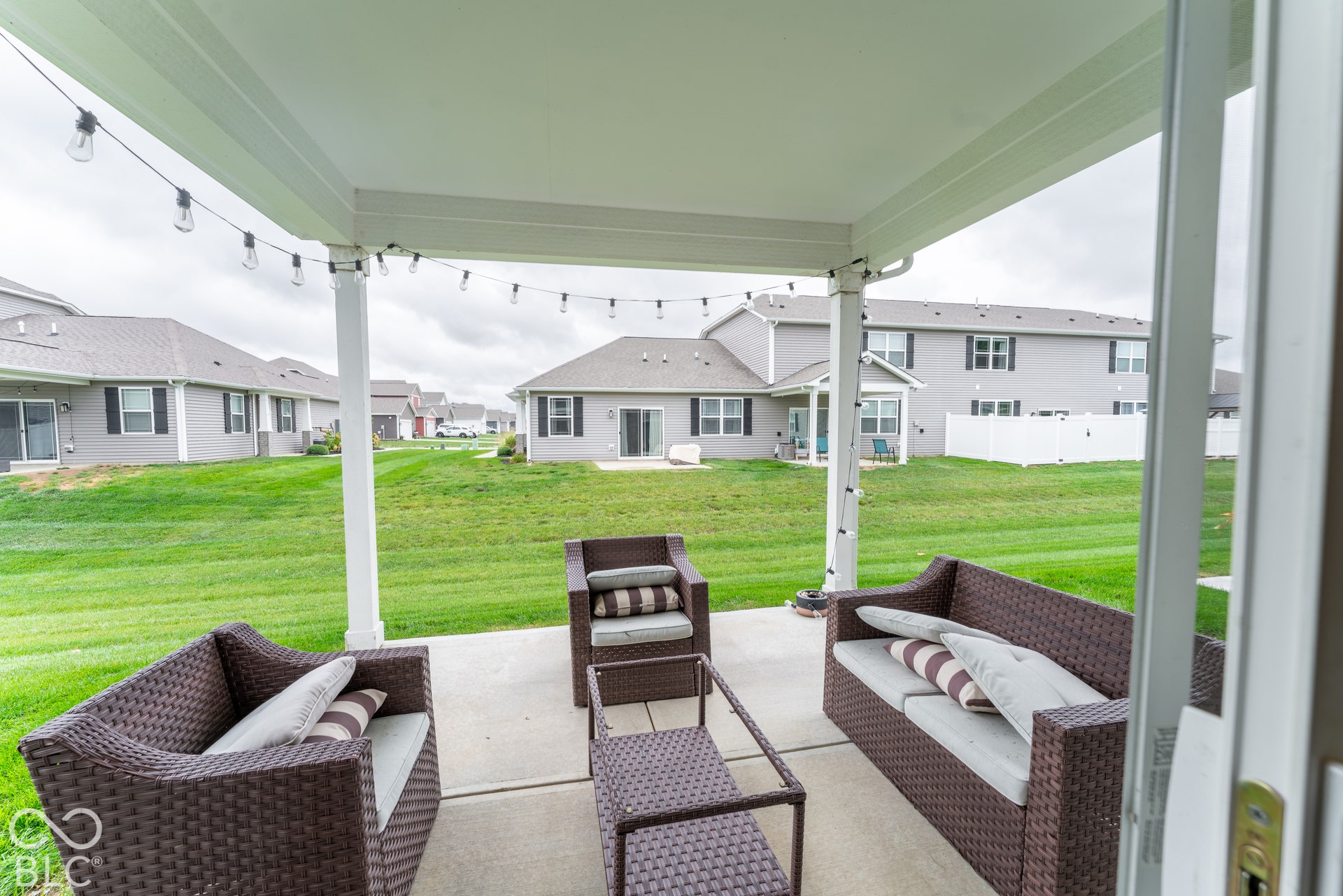 6432 Yuma, Whitestown, IN 46075 Covered concrete patio with string lighting and a manicured lawn