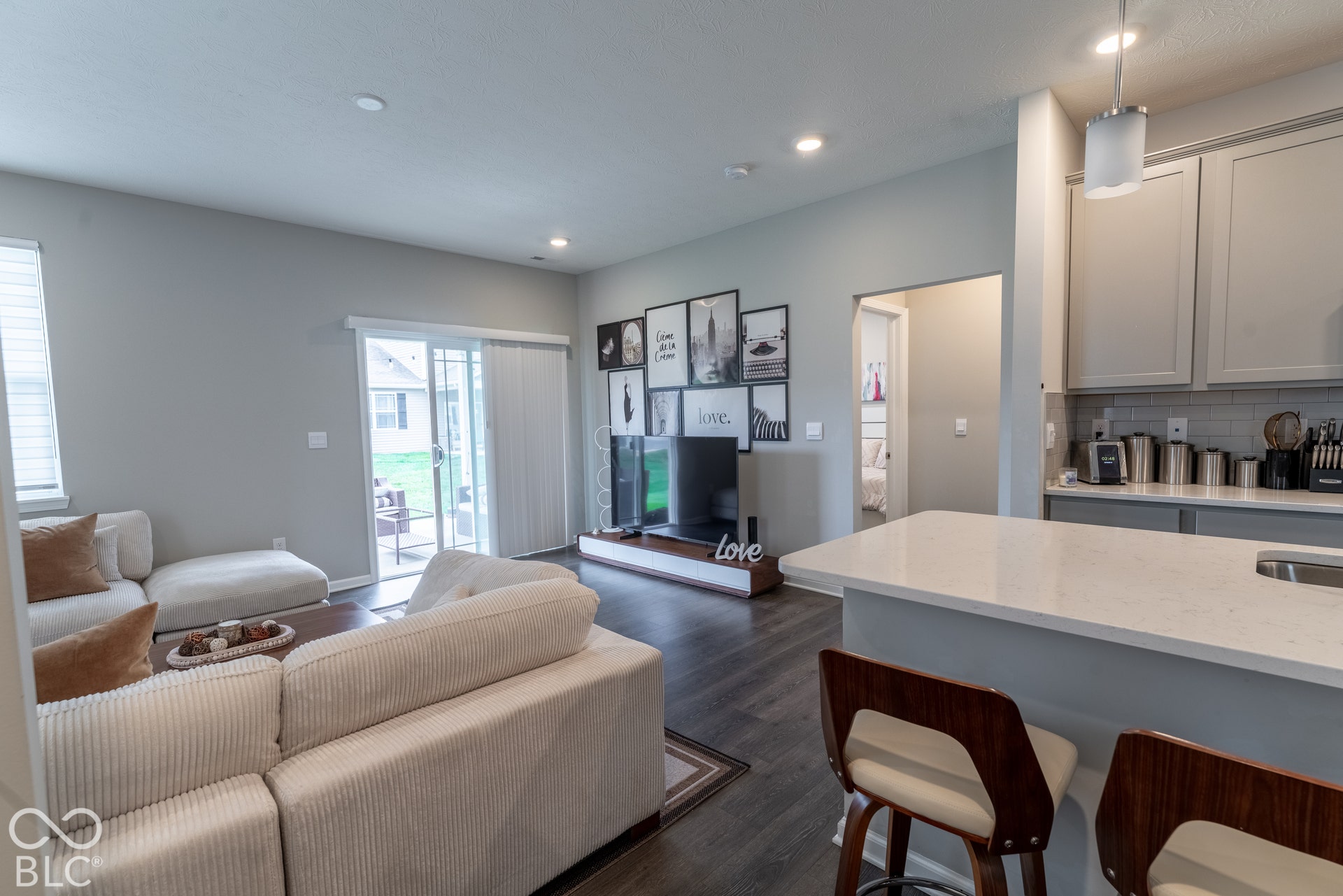 6432 Yuma, Whitestown, IN 46075 Open-concept living area featuring wood-finish flooring, recessed lighting, and a sliding glass door to an outdoor patio