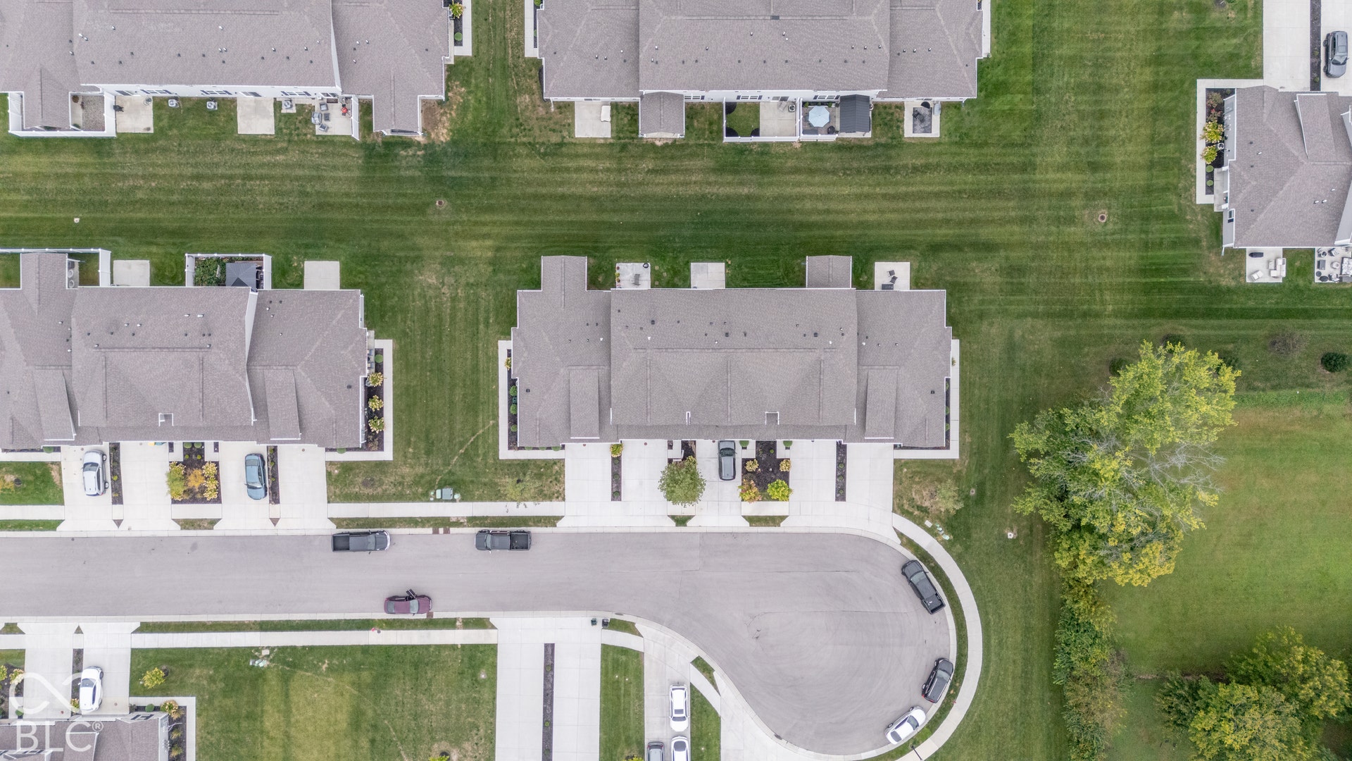 6432 Yuma, Whitestown, IN 46075 Aerial perspective featuring multiple residential structures with gray roofs, green lawns, and paved roads