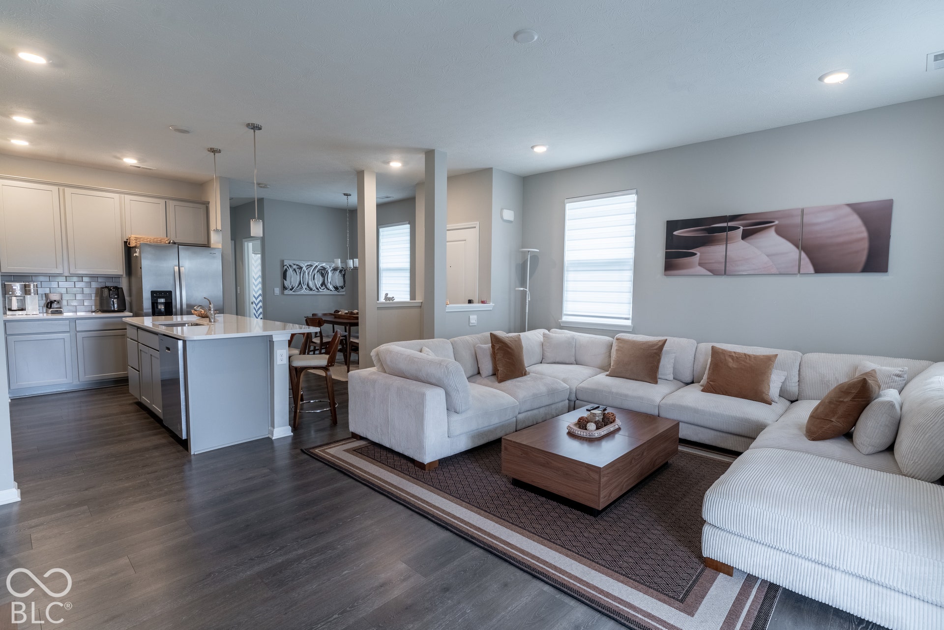 6432 Yuma, Whitestown, IN 46075 Open concept living area featuring wood-finish flooring, recessed lighting, and a kitchen with stainless steel appliances, light gray cabinetry, and a subway tile backsplash