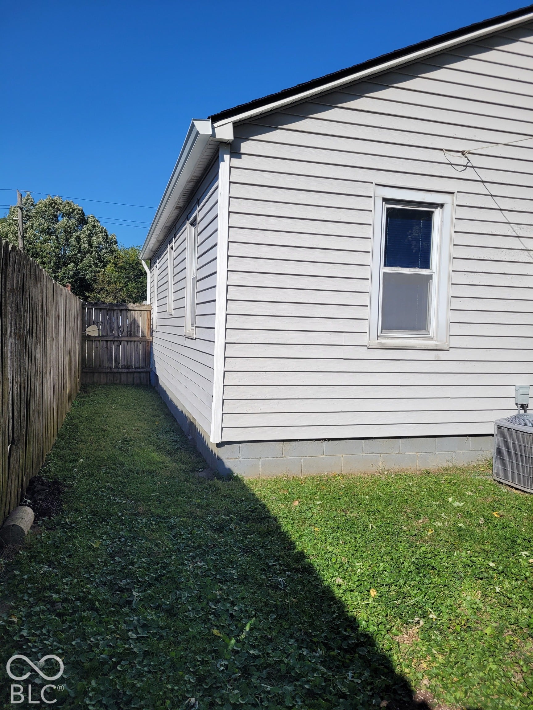 back yard - - side view showing fence and side of home