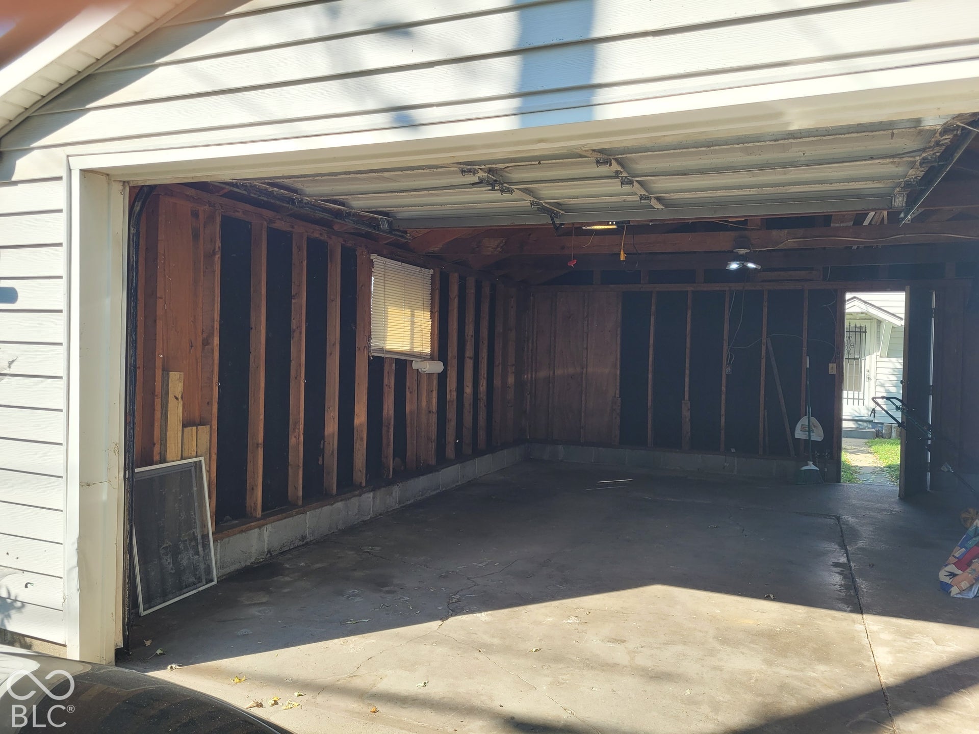 ample room for a large vehicle and lawn mower, yard tools