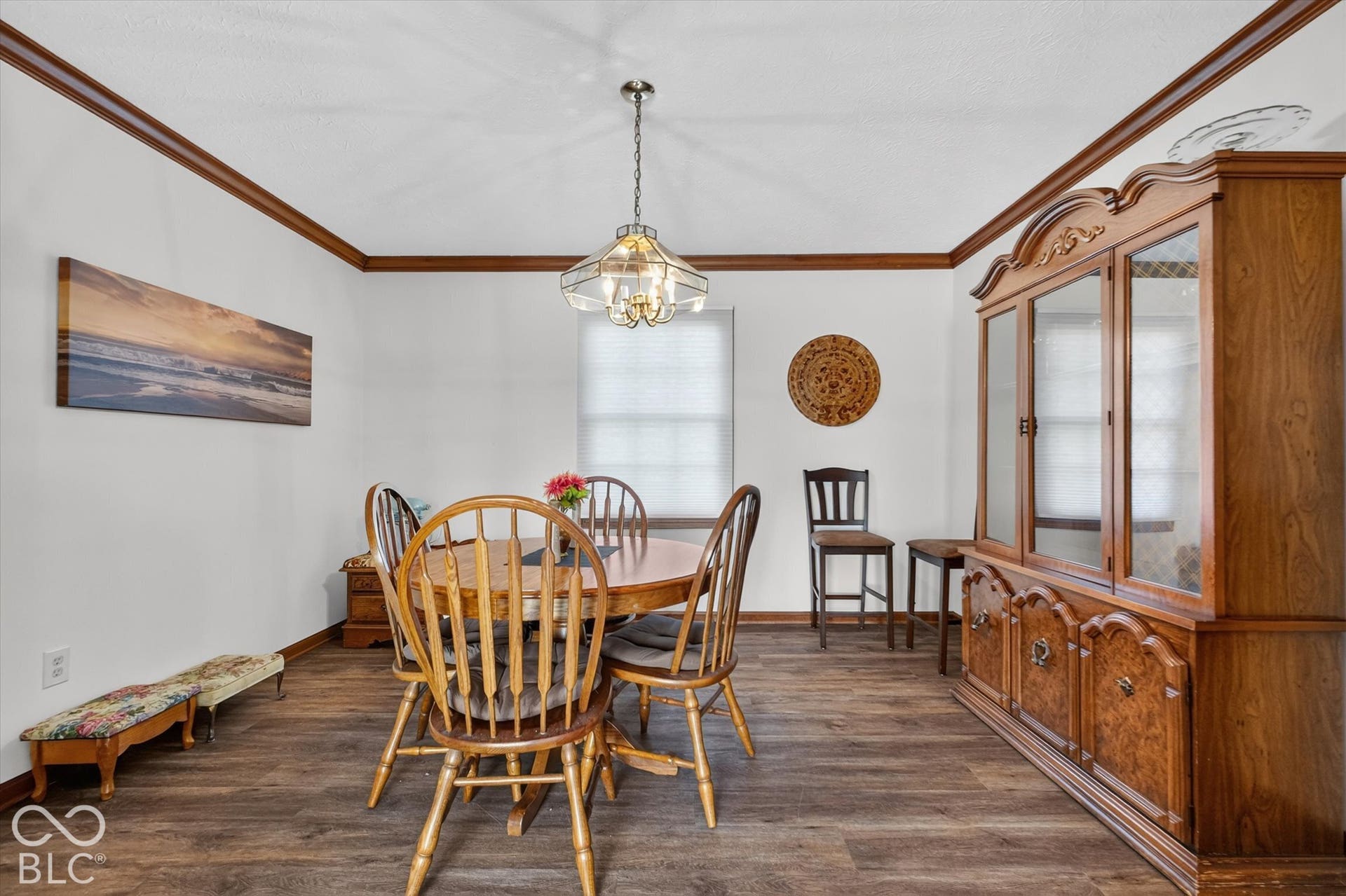 Wood-finish flooring with white walls and dark wood trim