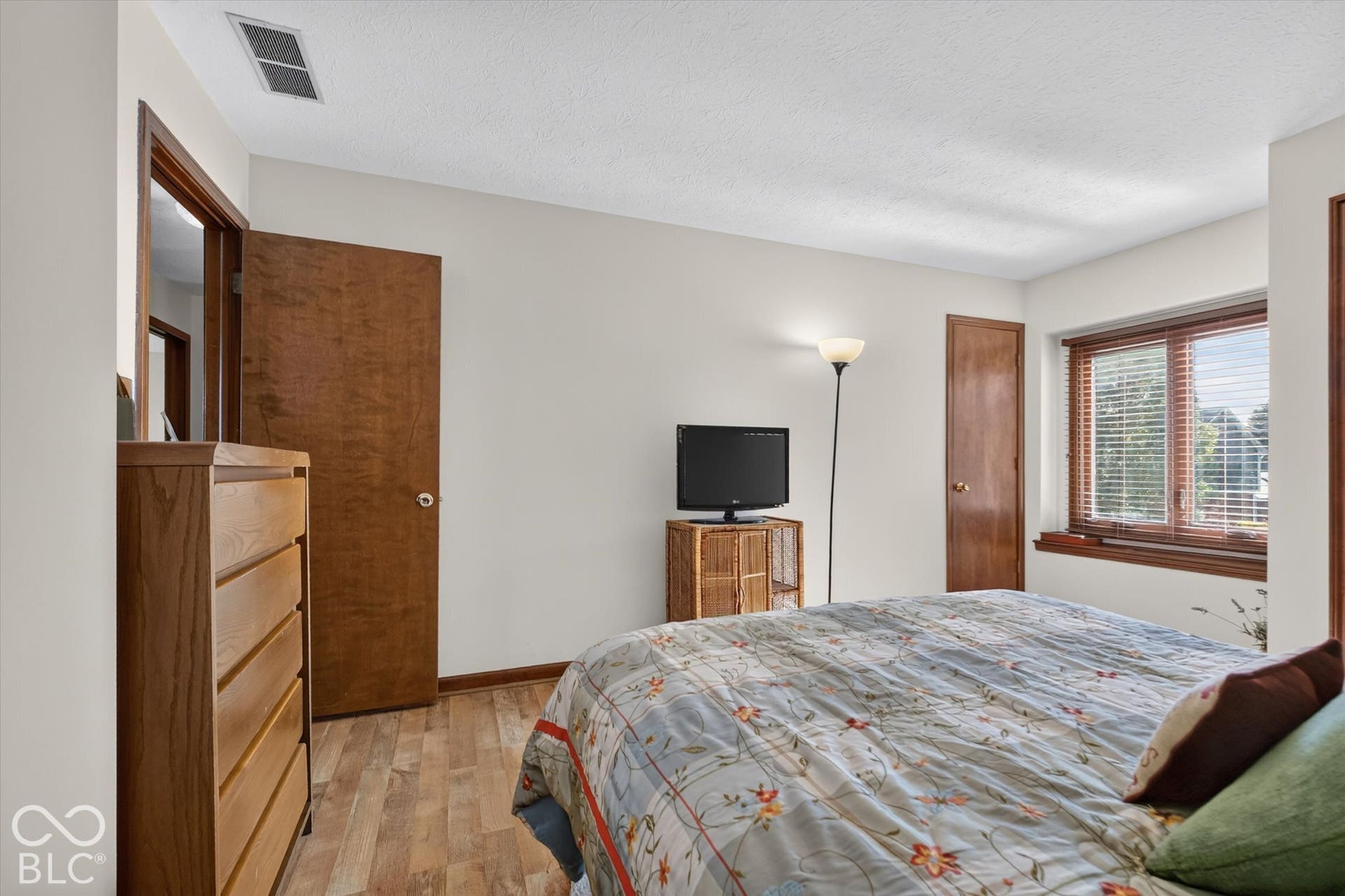 Wood-finish flooring with a white ceiling and walls