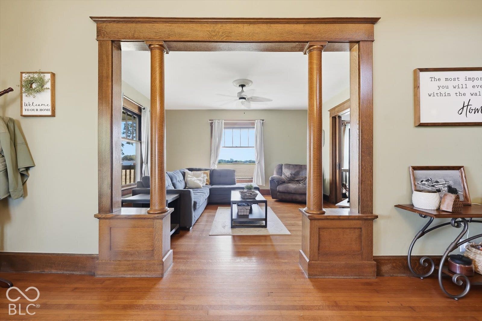 Wood-finish flooring throughout, with a decorative wood archway featuring columns