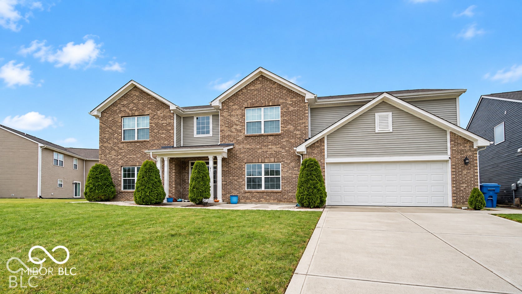 Virtually Altered - Brick and siding exterior with a covered entry, concrete driveway, and attached two-car garage