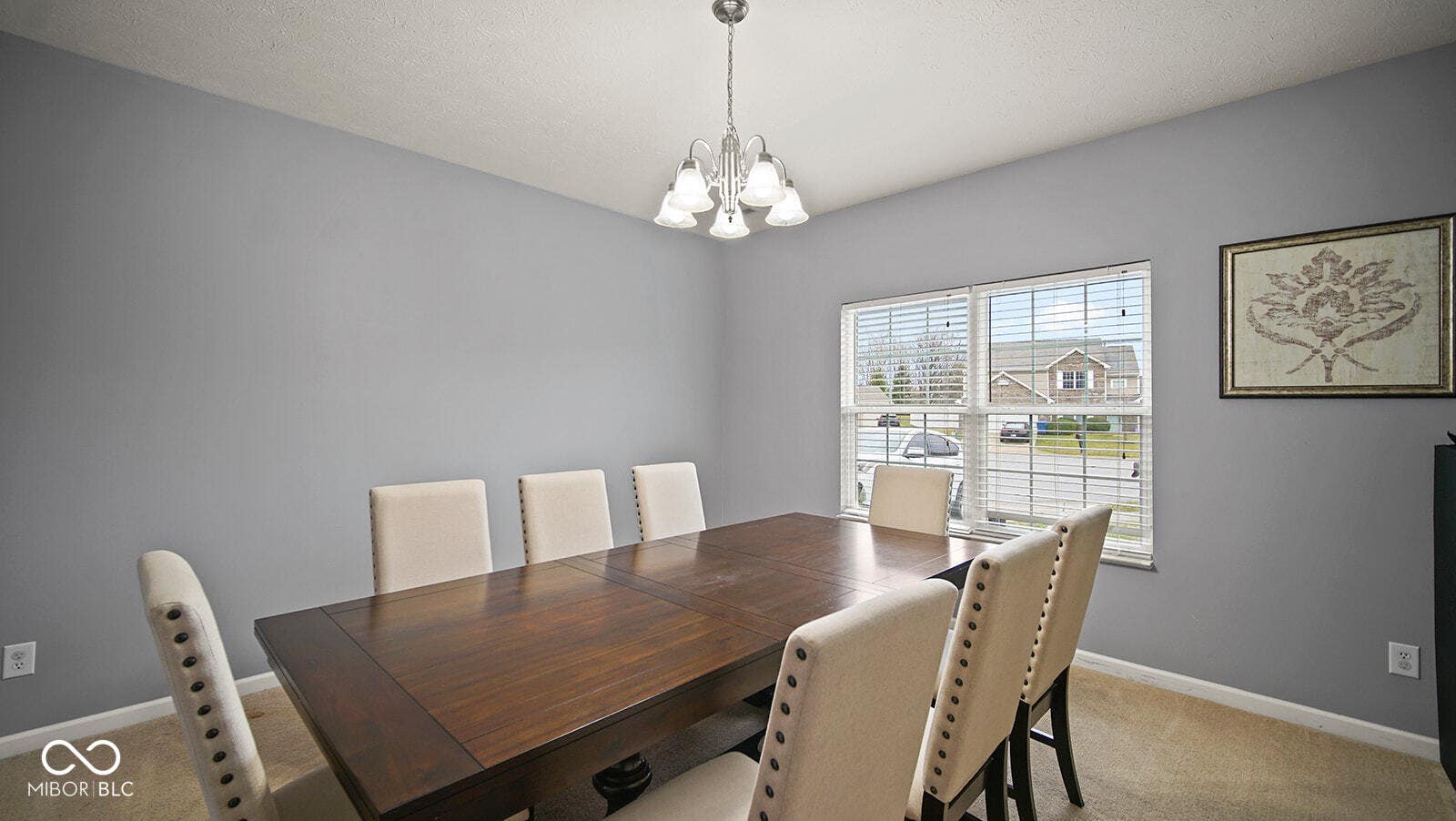 dining space with light carpet, baseboards, and an inviting chandelier