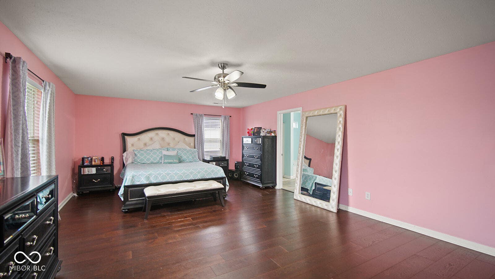 bedroom with baseboards, ceiling fan, and wood finished floors