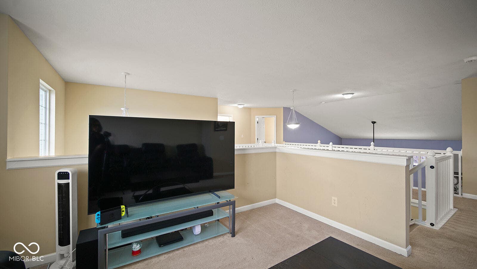 living room featuring baseboards, carpet flooring, and lofted ceiling