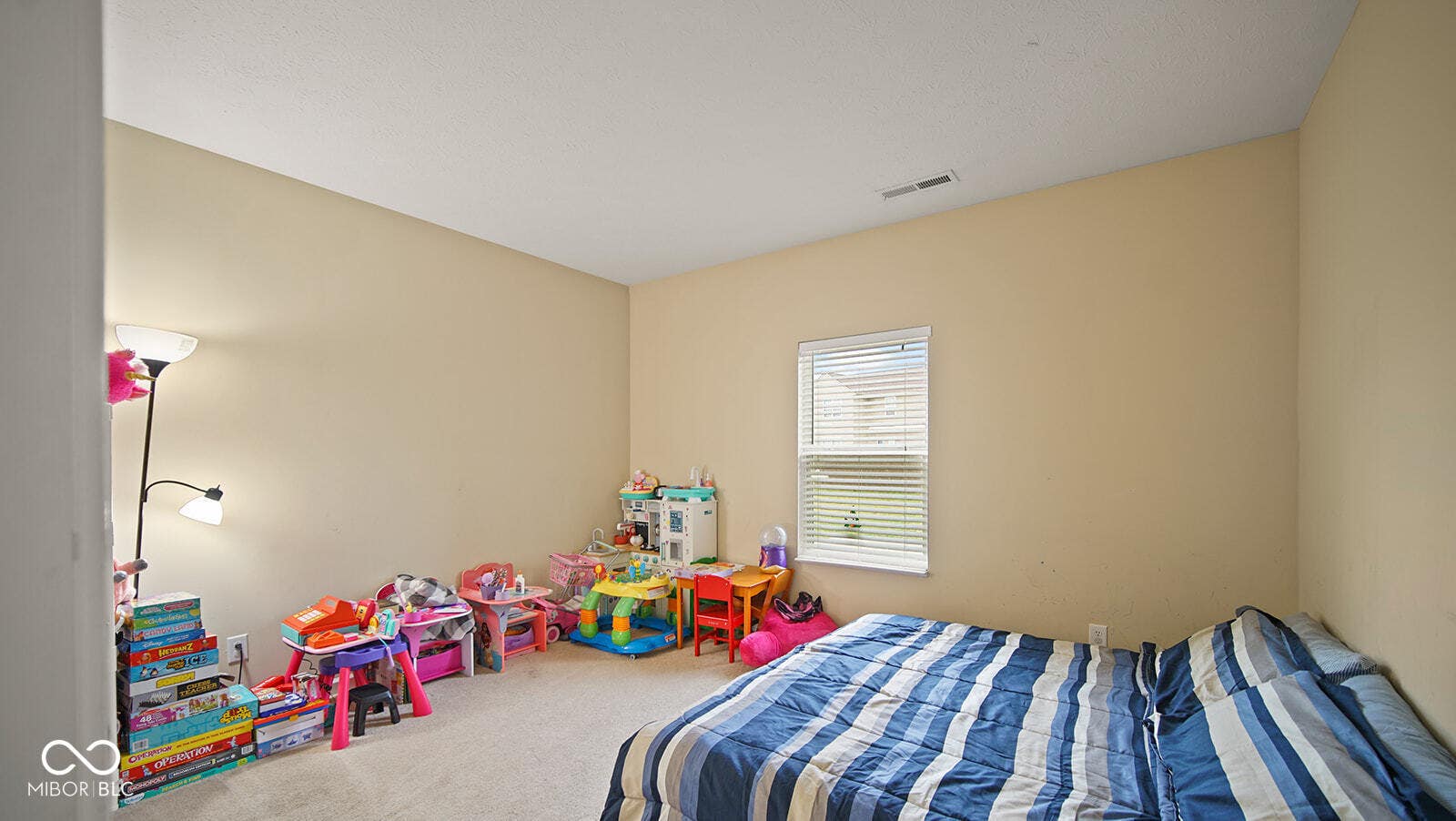 carpeted bedroom featuring visible vents