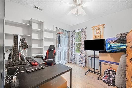 Built-in shelving, wood-finish flooring, and a ceiling fan