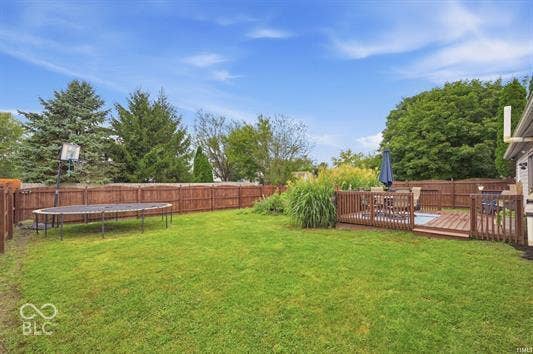Expansive grassy lawn with a wood-fenced perimeter