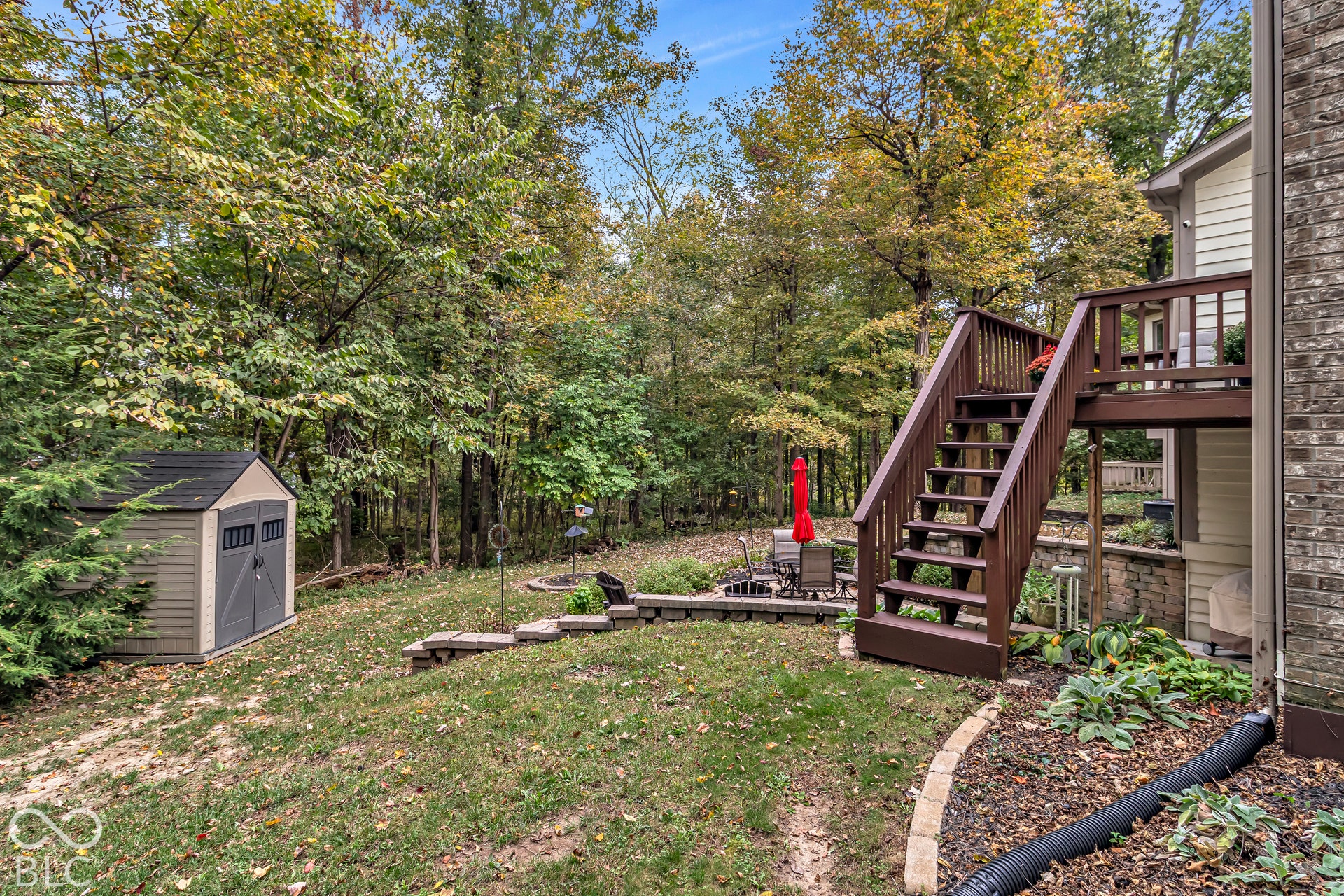 Deck leading down into yard with storage shed