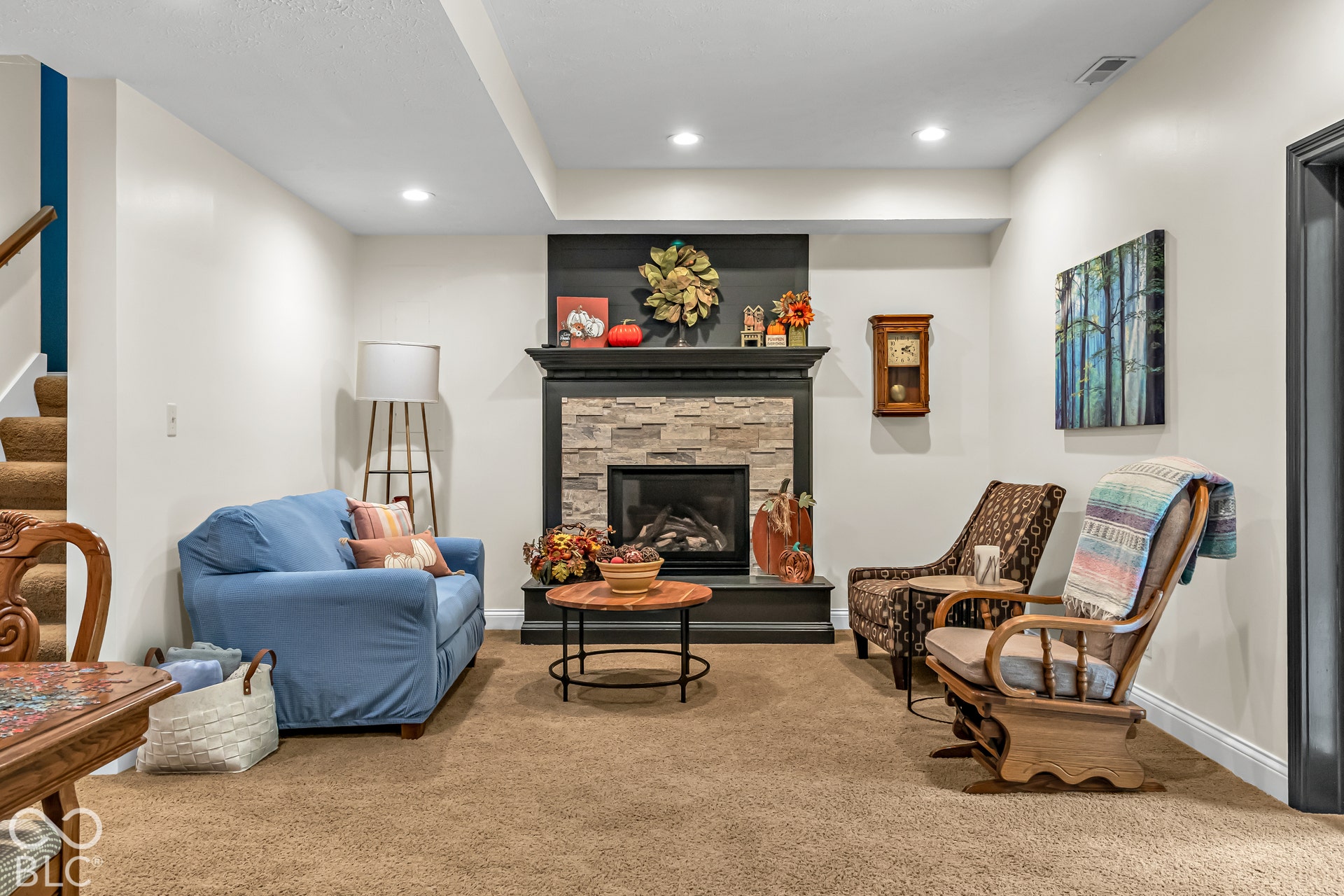 Family room in basement with fireplace