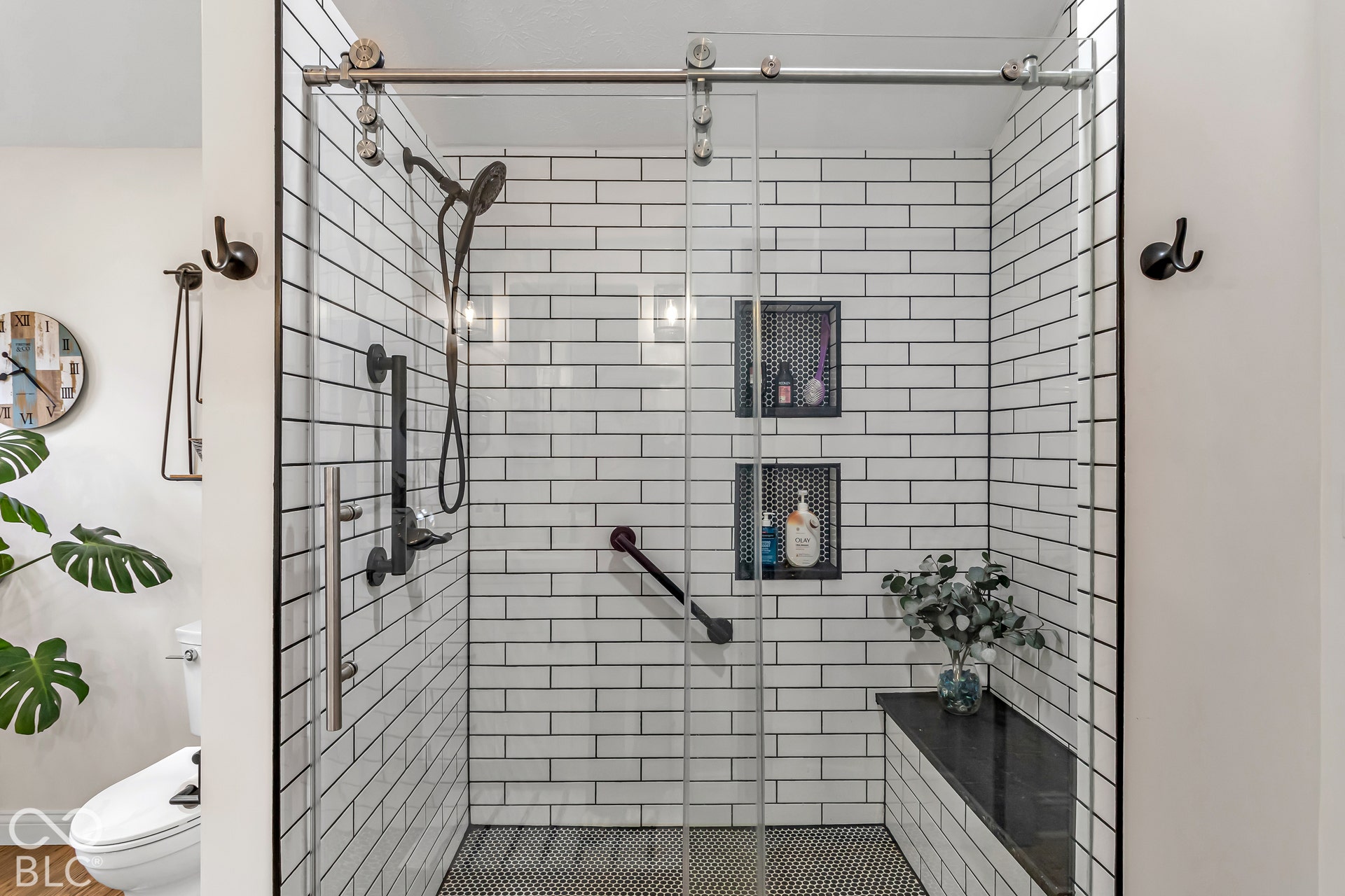 Primary bath with tile shower and glass door.