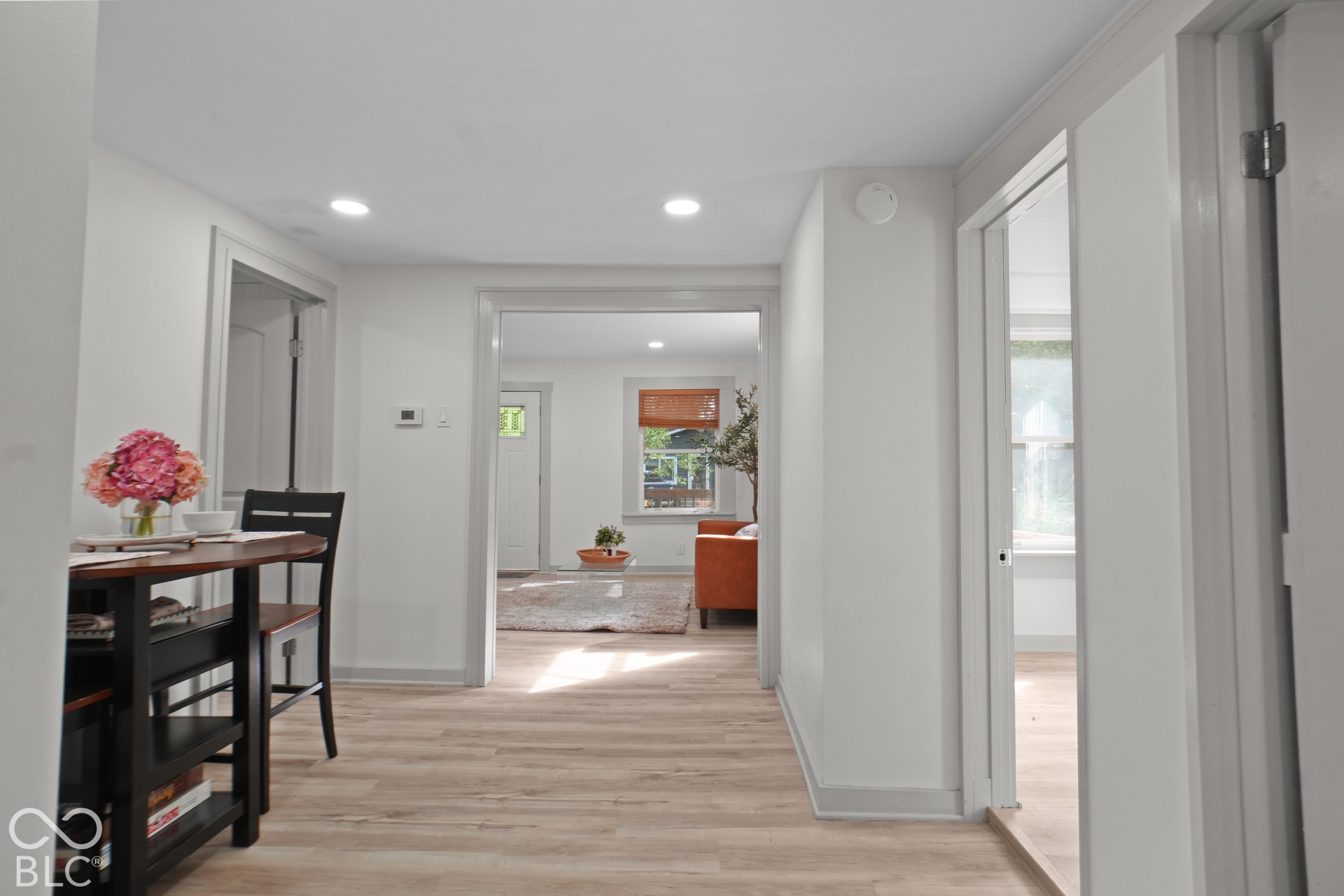 Recessed lighting, light wood-finish flooring, white walls, and white trim