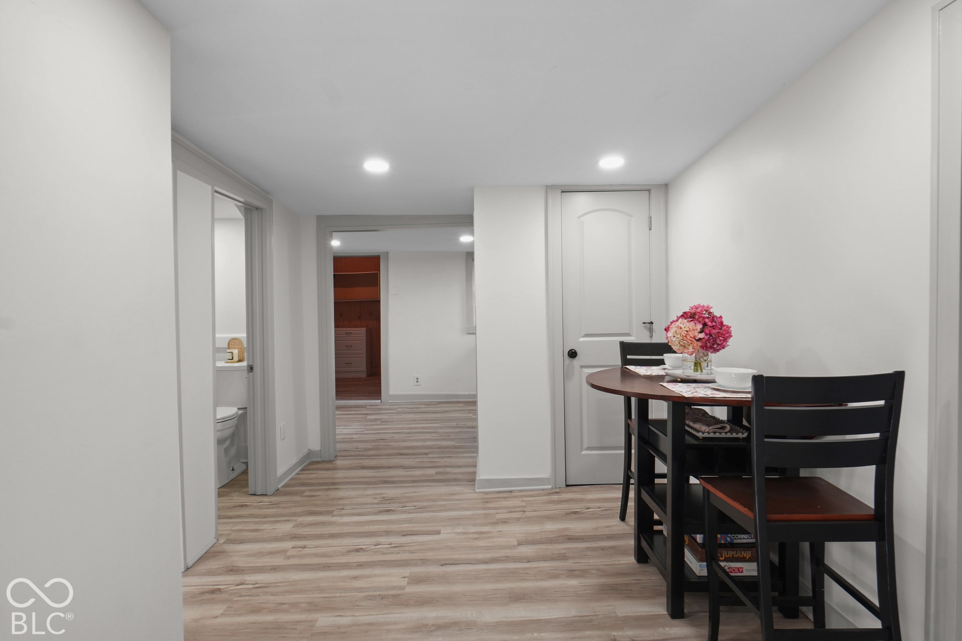 Wood-finish flooring throughout, recessed lighting, and white trim