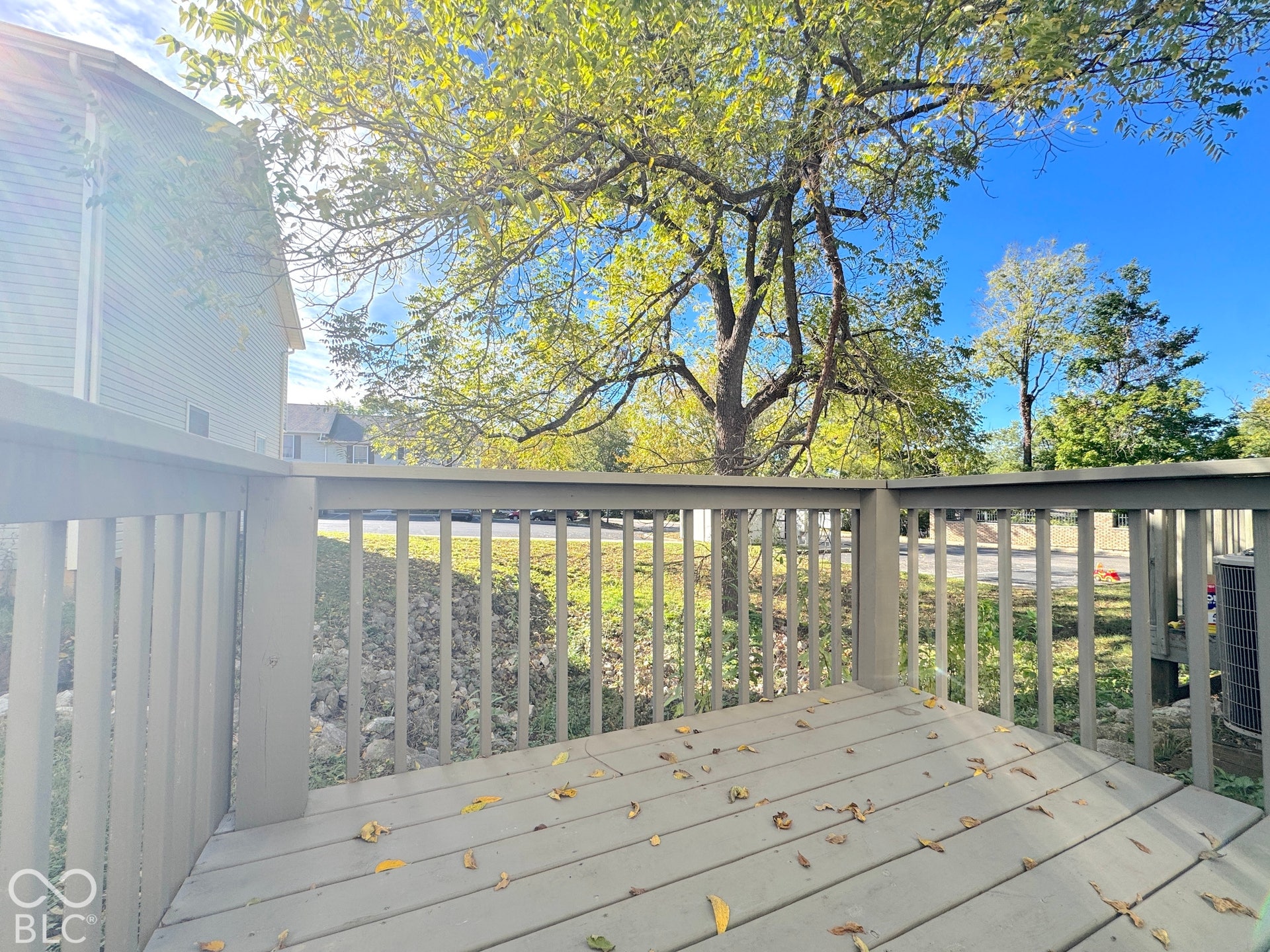 Wood-tone deck with matching railing, providing an outdoor extension of the property