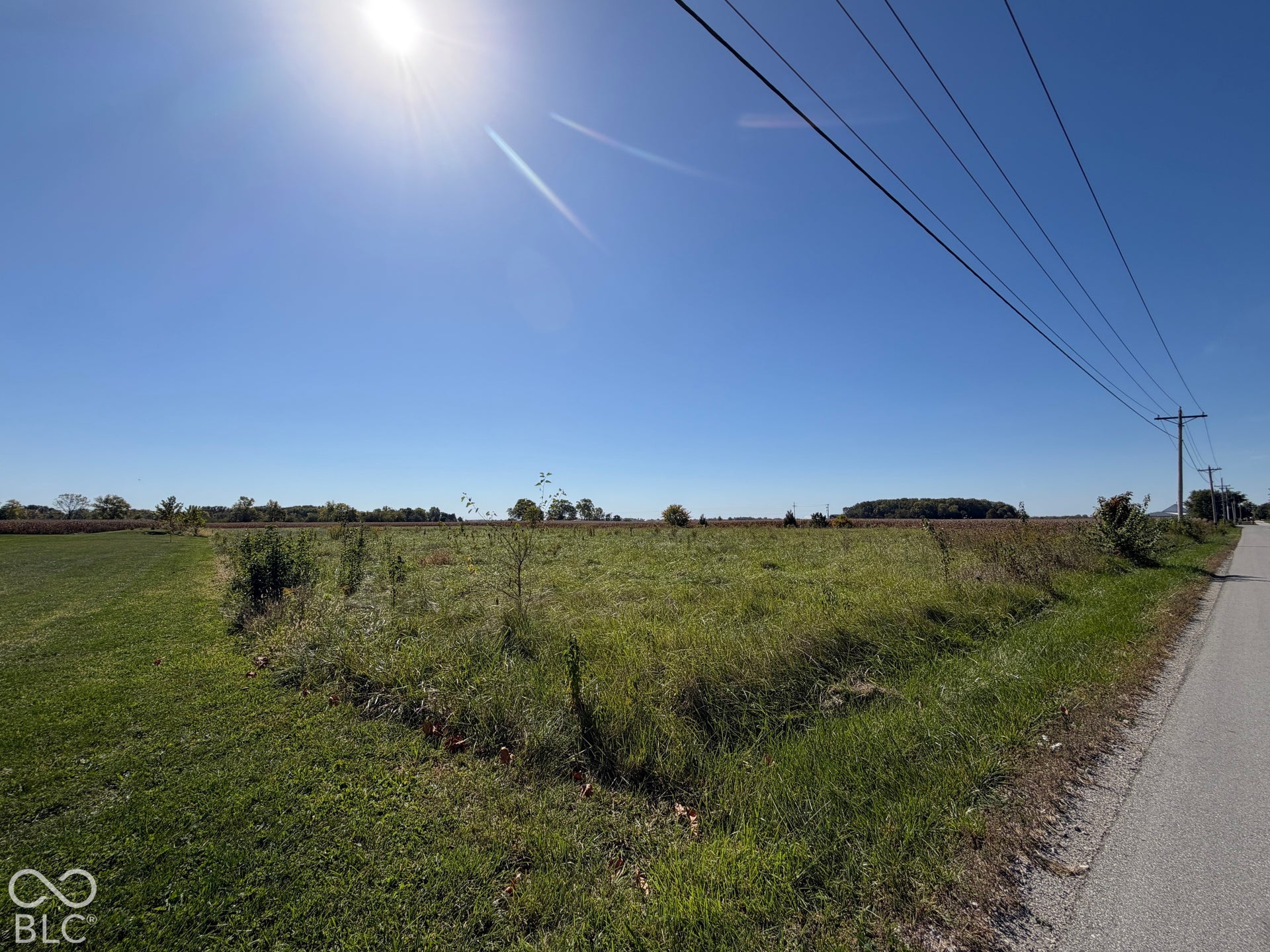 Left Angle from Front at North East Corner of Property - Showing Road and Overhead Wires
