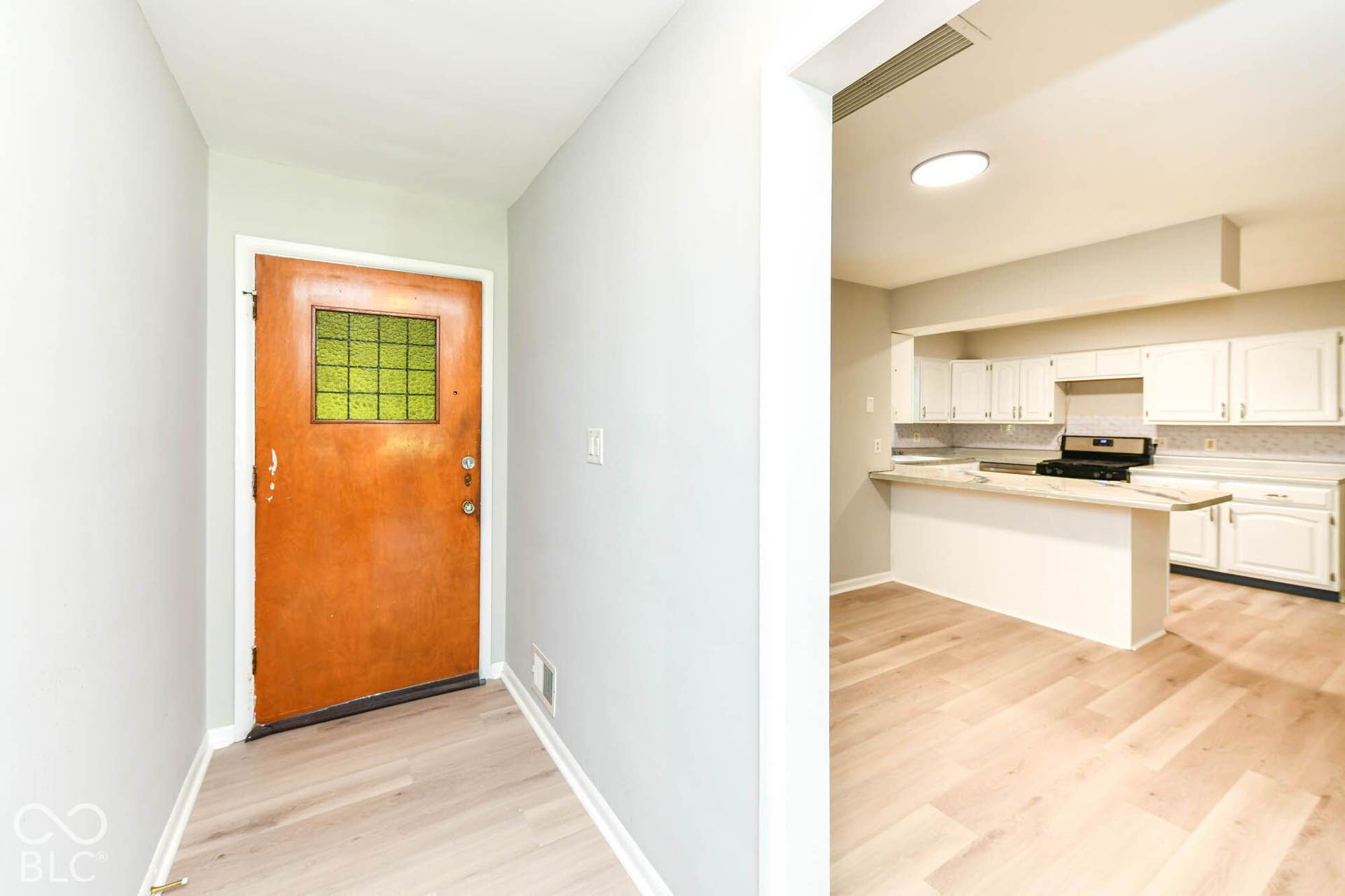 6401 Orinoco Avenue, Indianapolis, IN 46227 Wood-finish flooring throughout, with a wood-panel entry door featuring a decorative glass insert