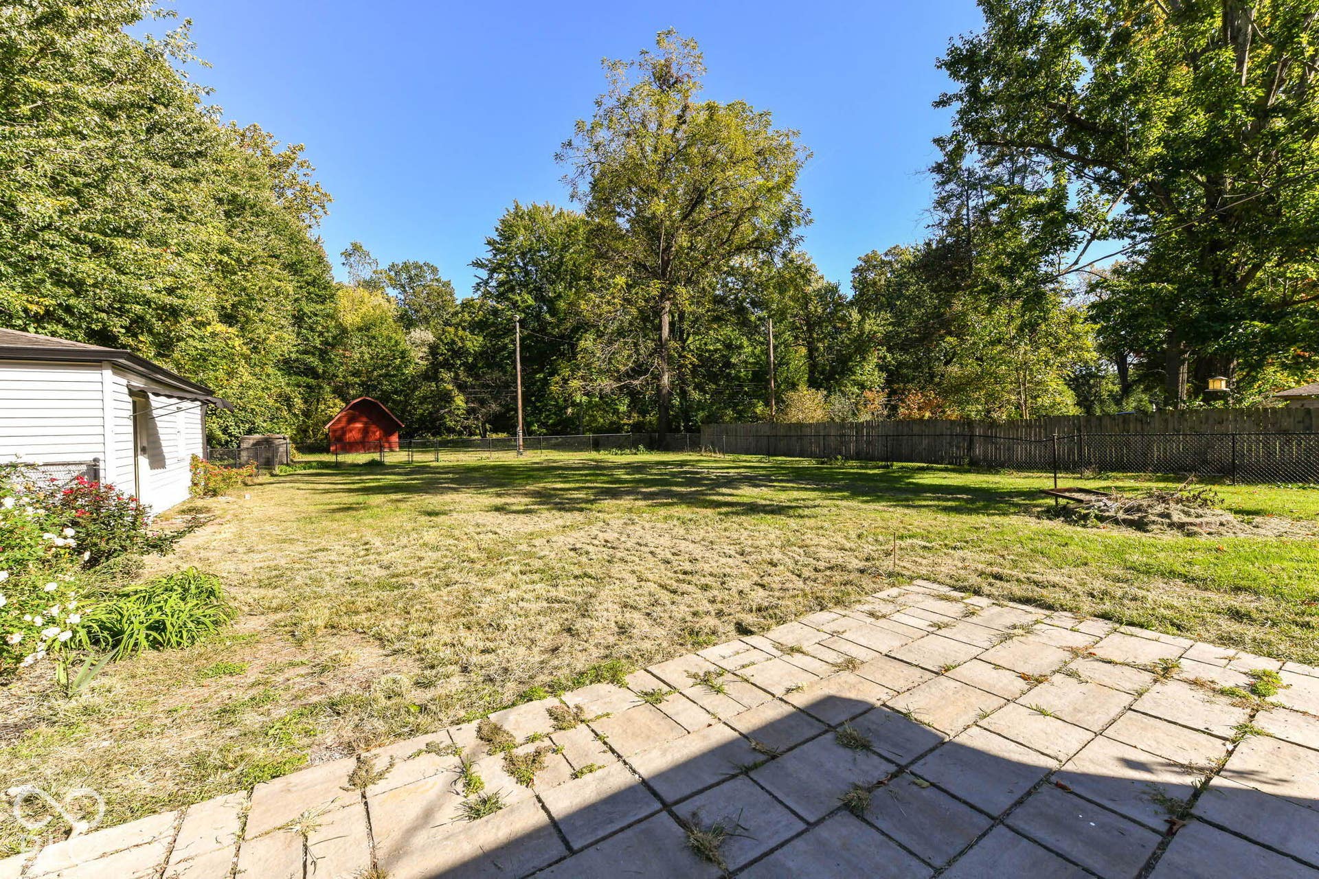 6401 Orinoco Avenue, Indianapolis, IN 46227 Expansive outdoor area featuring a paver patio and a red storage shed