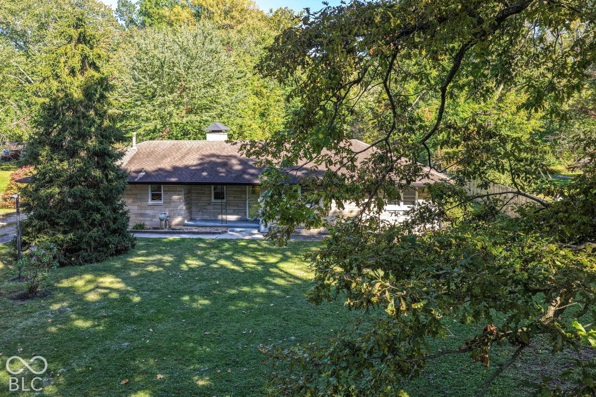 6401 Orinoco Avenue, Indianapolis, IN 46227 Stone exterior residence with a shingle roof and a front porch