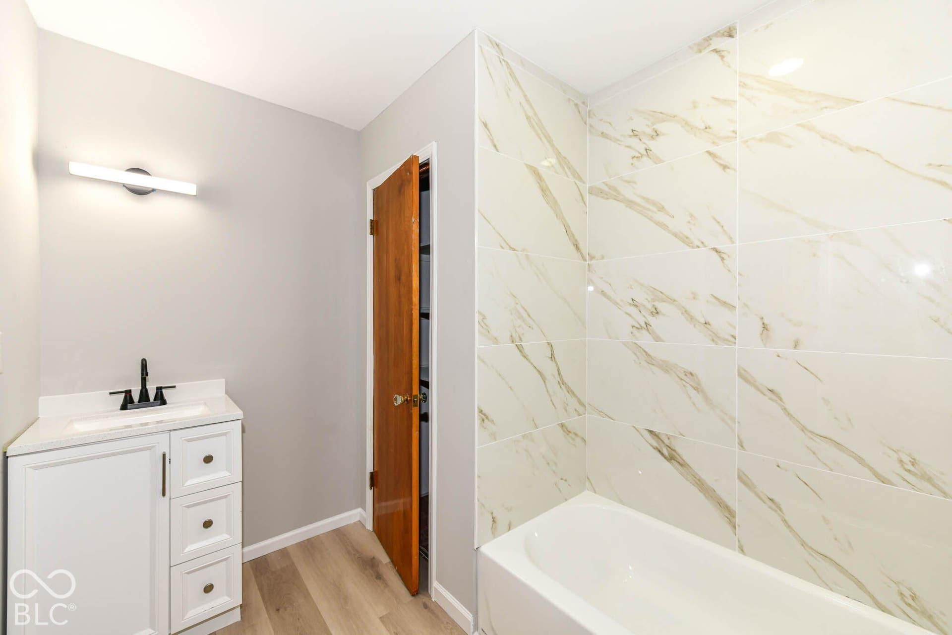 6401 Orinoco Avenue, Indianapolis, IN 46227 White vanity with a rectangular sink, black faucet, and white countertop