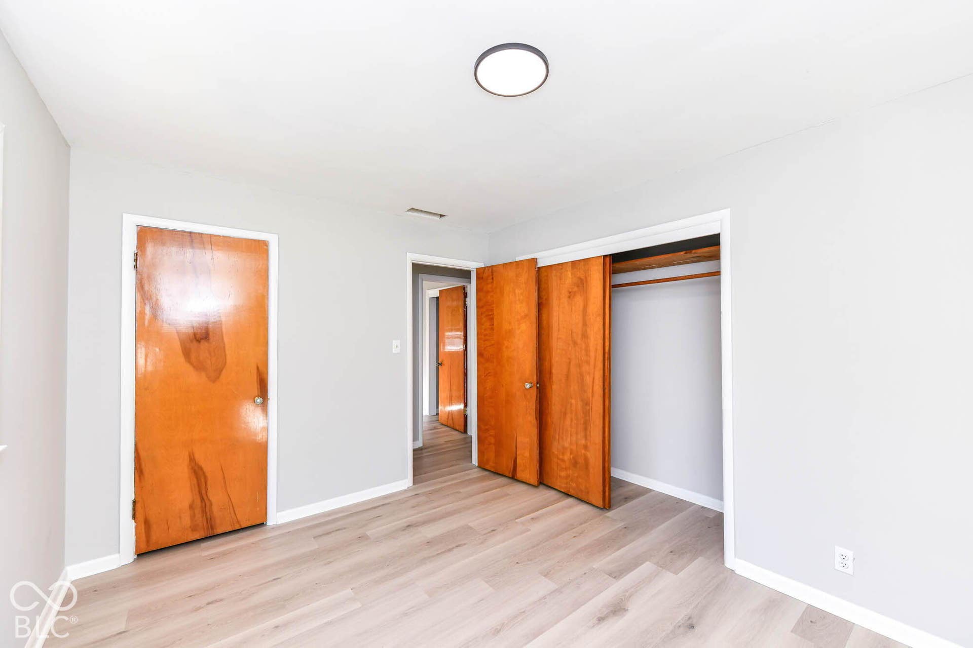 6401 Orinoco Avenue, Indianapolis, IN 46227 Spacious interior with light wood-finish flooring, light gray wall finishes, and a flush mount ceiling light
