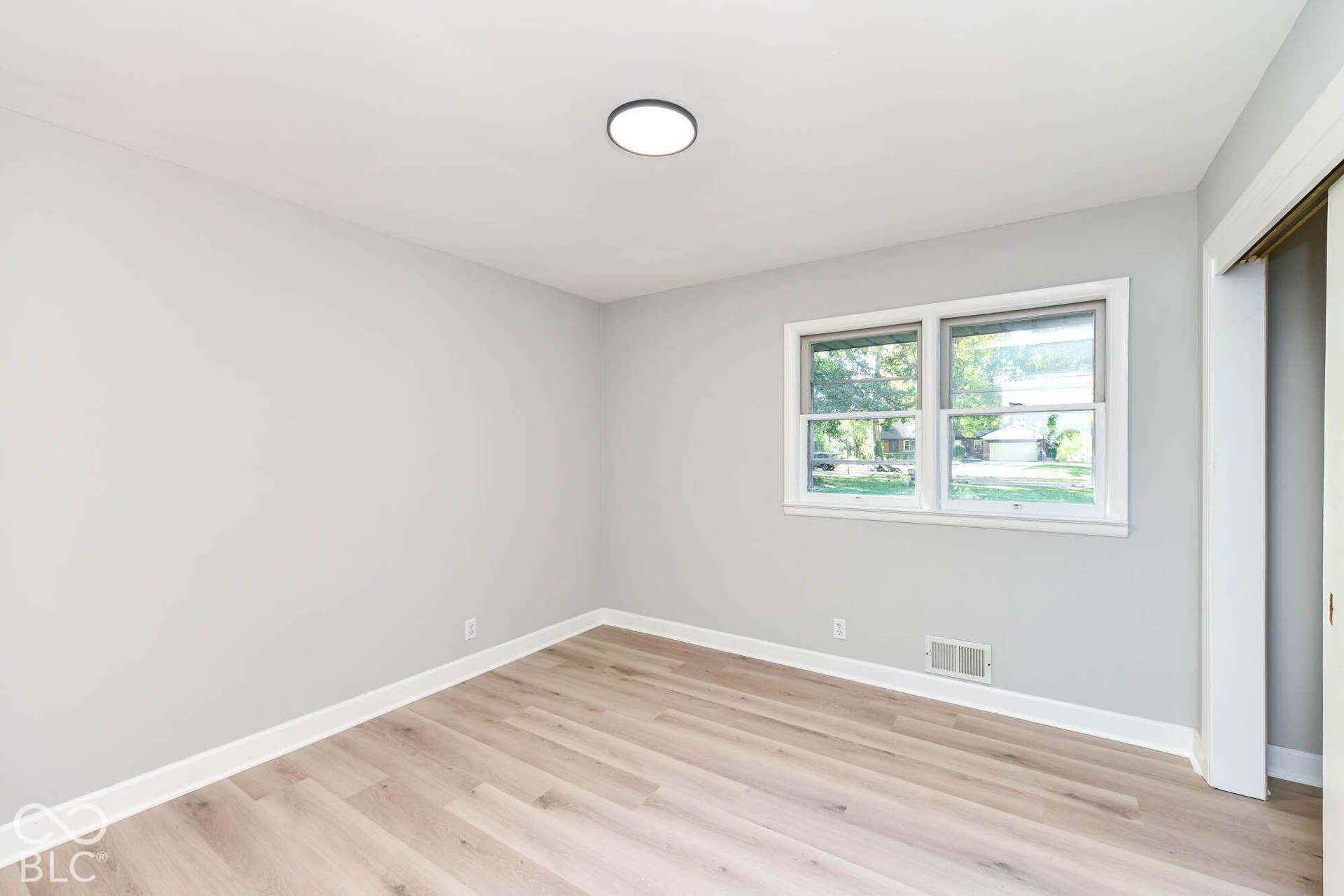 6401 Orinoco Avenue, Indianapolis, IN 46227 Wood-finish flooring with white baseboards, light gray walls, and a ceiling-mounted light fixture