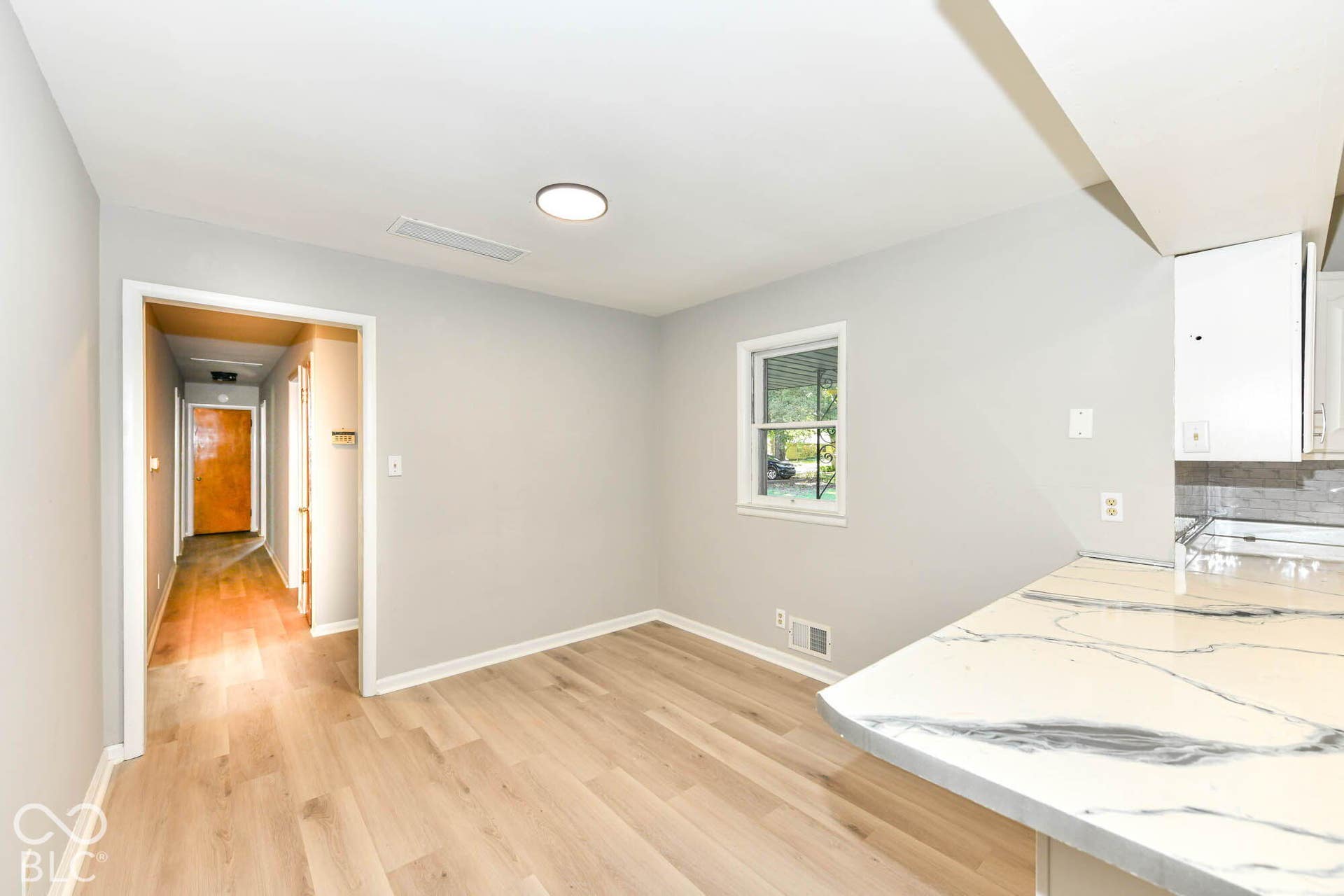 6401 Orinoco Avenue, Indianapolis, IN 46227 Wood-finish flooring throughout, bright white walls, recessed lighting, and a window with outdoor scenery