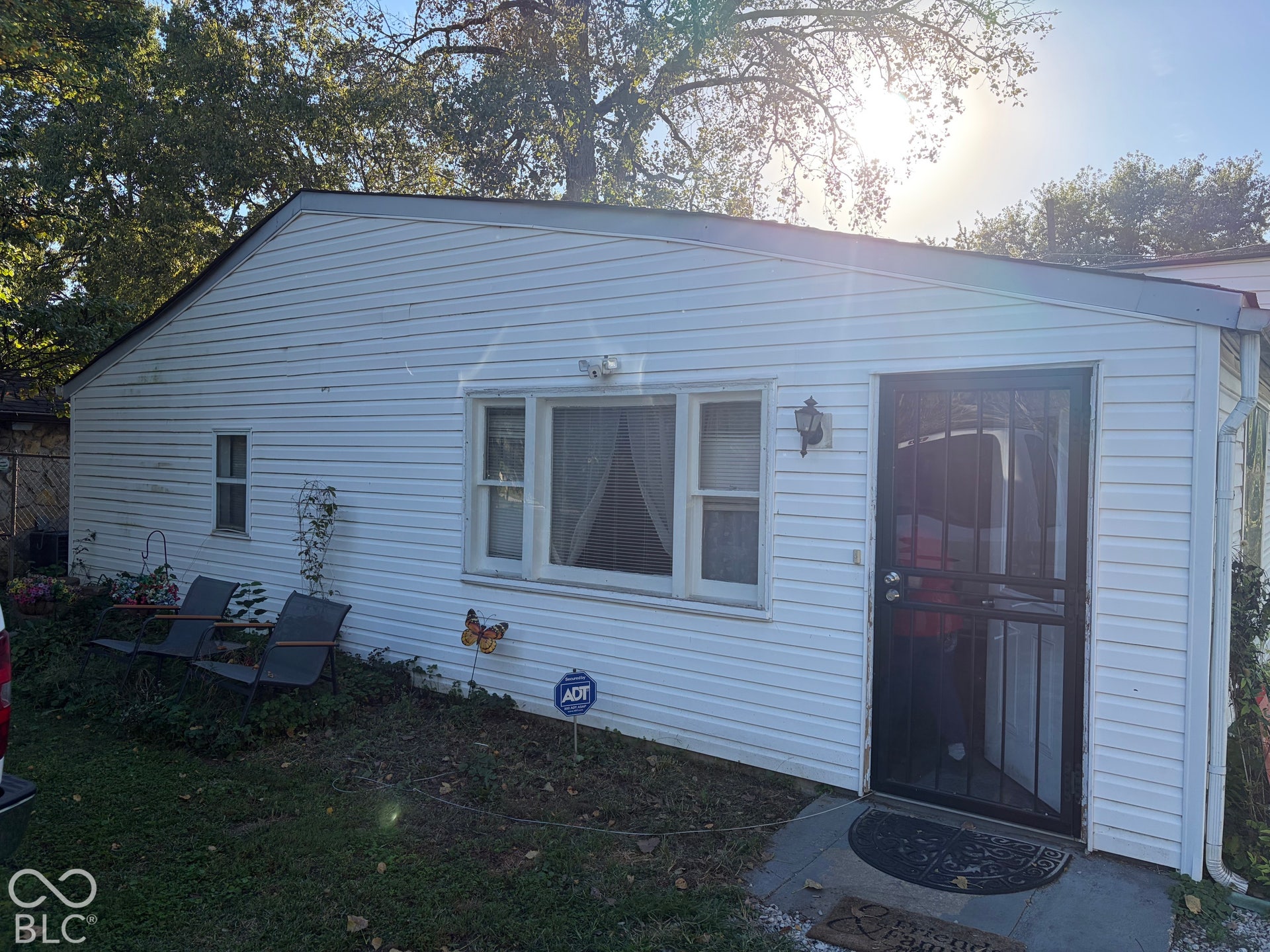 White siding exterior with an asphalt shingle roof