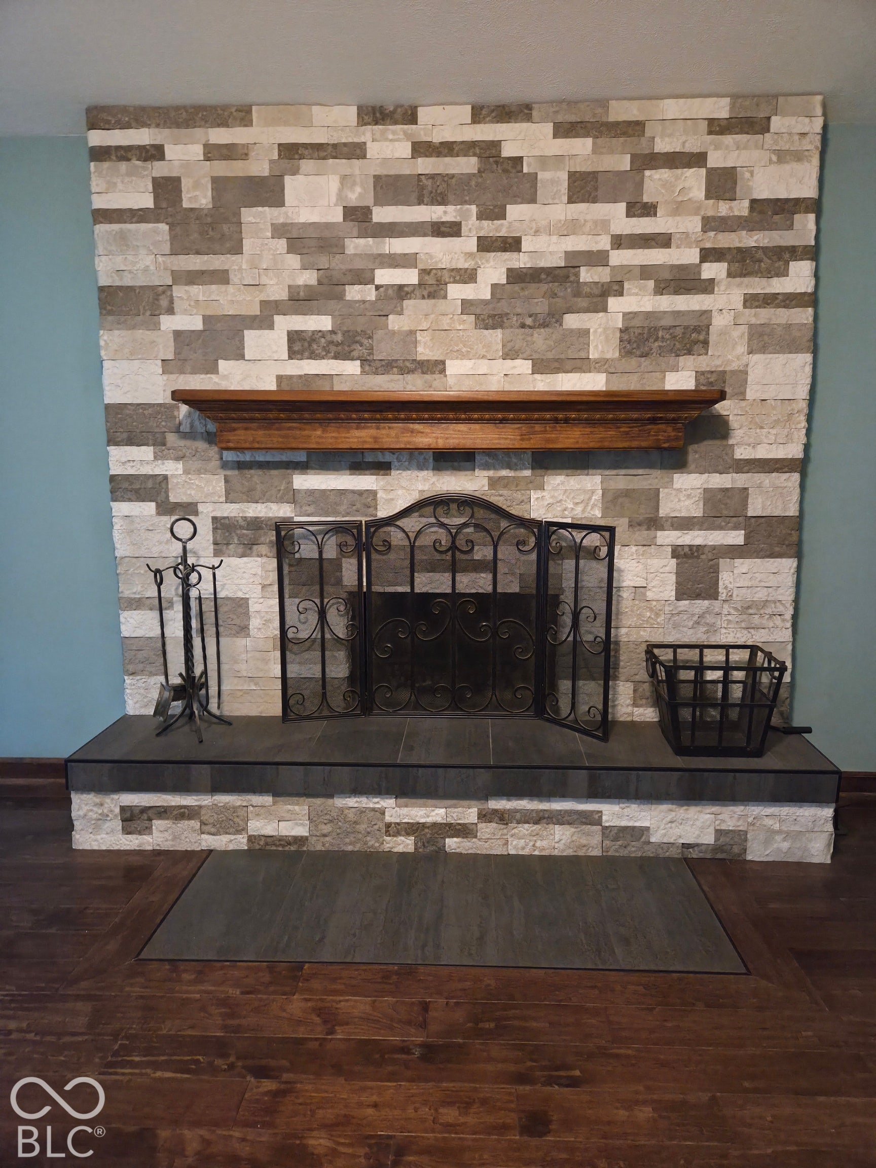6614 Weil Drive, Brownsburg, IN 46112 Fireplace featuring a stacked stone surround, wood mantel, and a tiled hearth