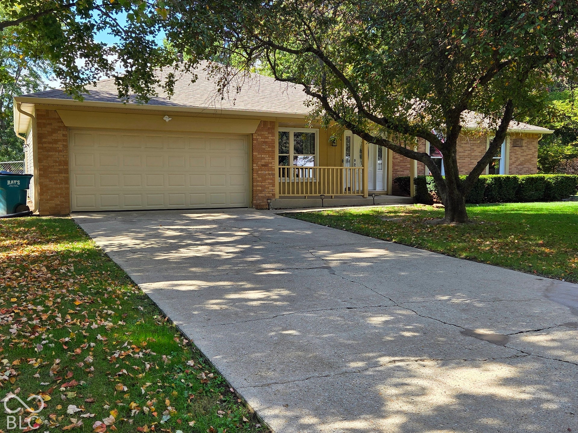 6614 Weil Drive, Brownsburg, IN 46112 Brick and siding exterior with a 2 car attached garage, concrete driveway, and covered front porch with wood railings.