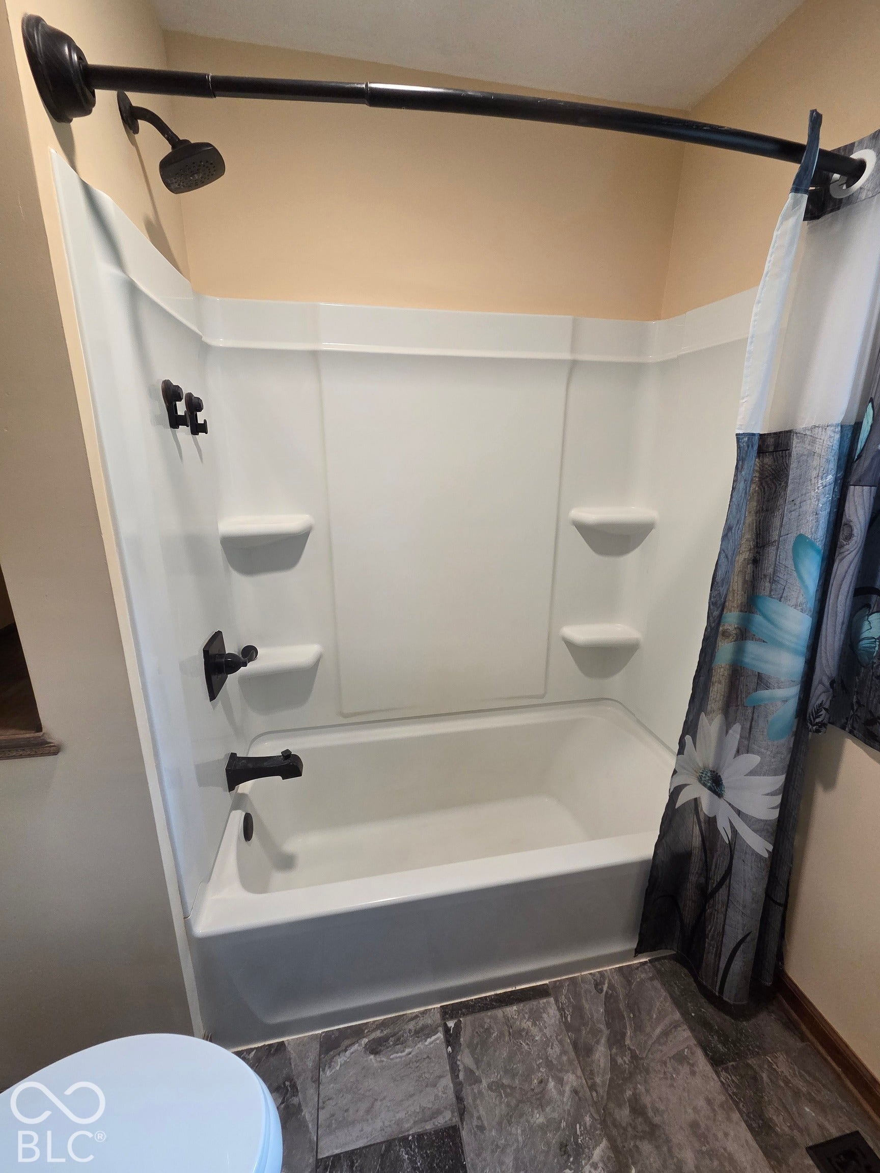 6614 Weil Drive, Brownsburg, IN 46112 White bathtub and shower combination with dark bronze fixtures