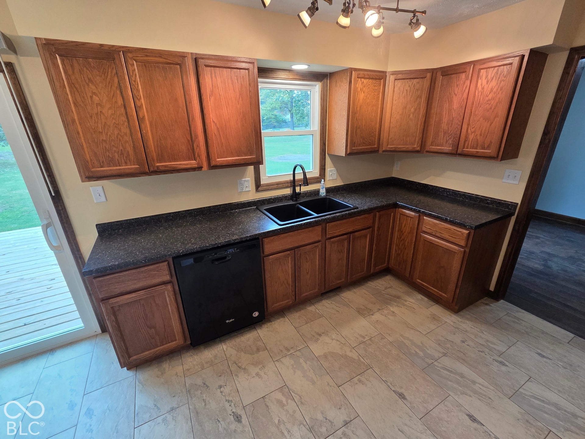 6614 Weil Drive, Brownsburg, IN 46112 Wood-finish cabinetry paired with dark speckled countertops