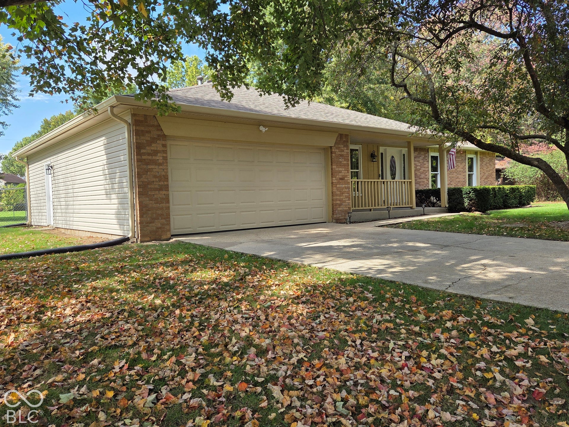 6614 Weil Drive, Brownsburg, IN 46112 Brick and siding exterior with a 2 car attached garage, covered front porch, and a concrete driveway.