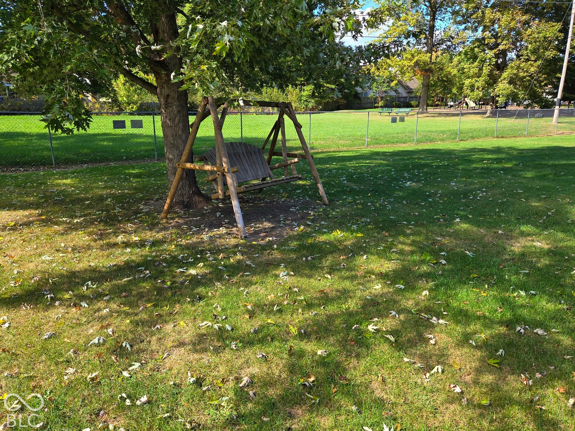 6614 Weil Drive, Brownsburg, IN 46112 .57 acre yard with mature trees and a chain-link fence.
